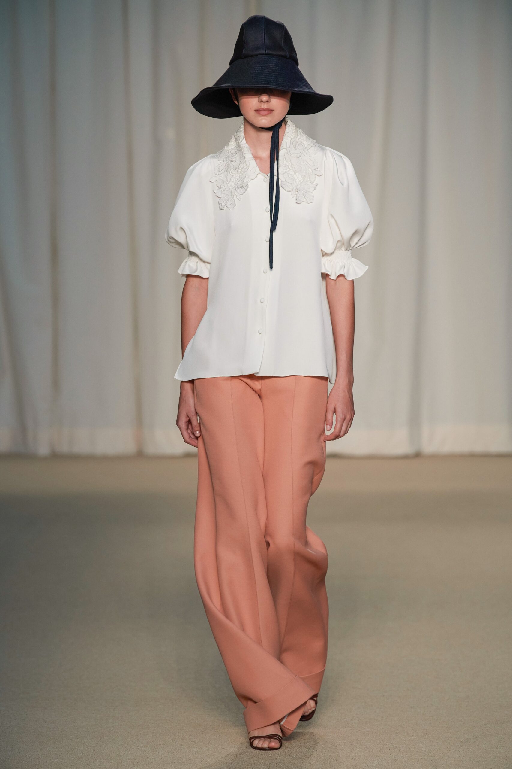 white relaxed blouse with peach pants