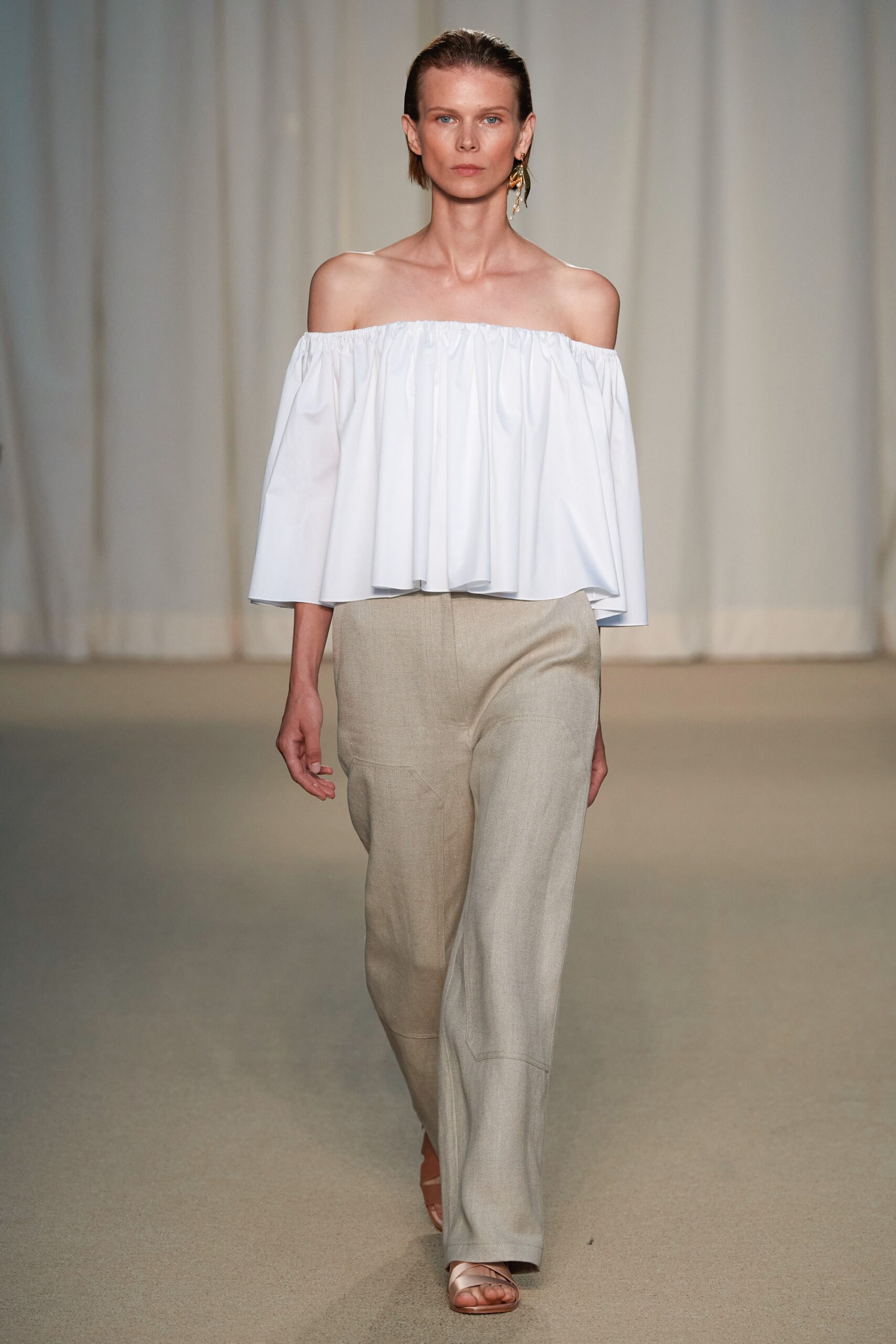 white off-shoulder top and beige wide-leg pants