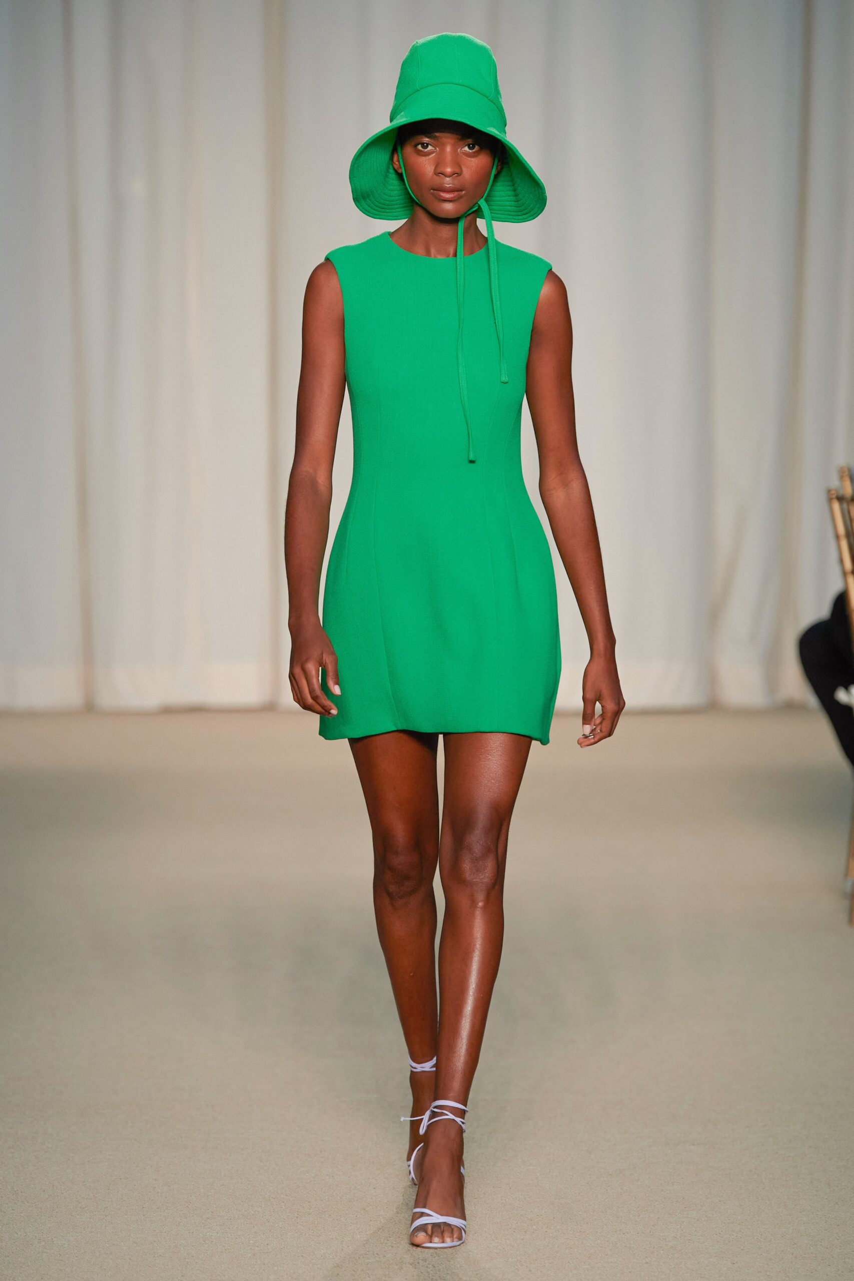 green fitted mini dress with bucket hat