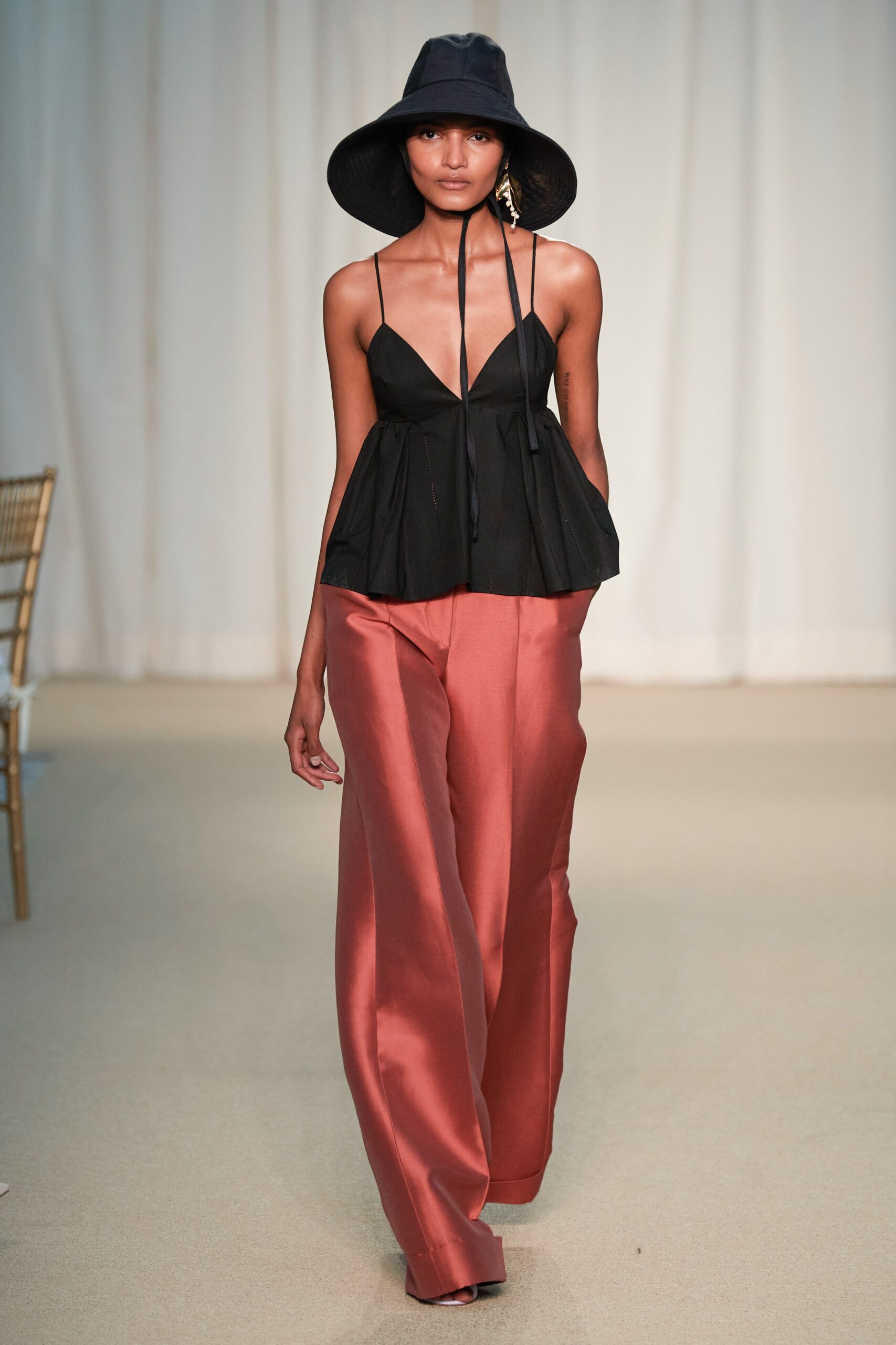 black fitted top with orange pants