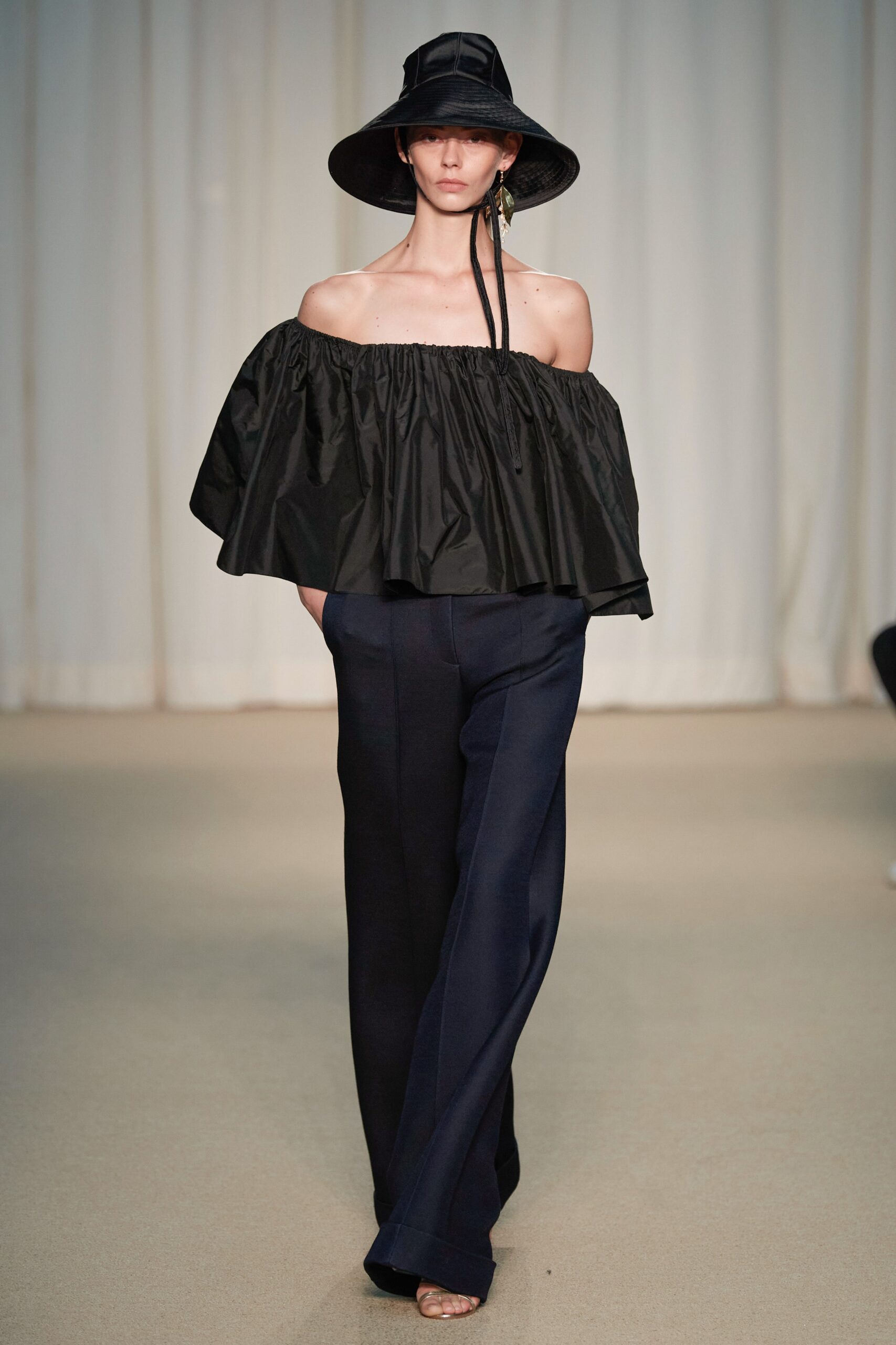 black off-shoulder top and navy pants