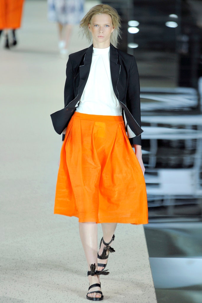black blazer white top orange skirt