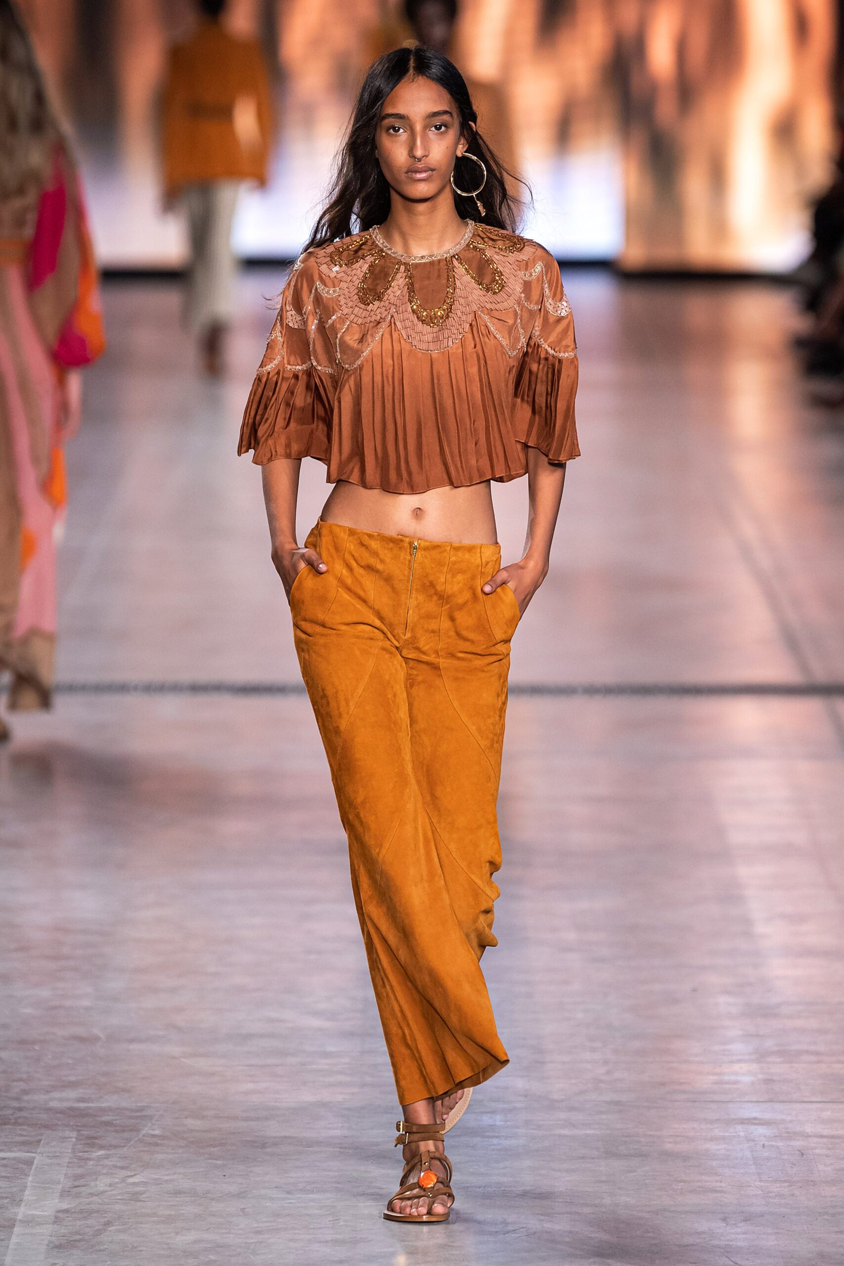 cropped orange silk top and brown suede pants