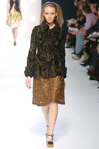 black velvet fitted jacket and gold embroidered skirt