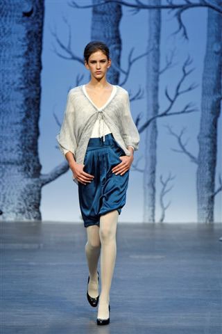 white silk relaxed top and blue satin skirt