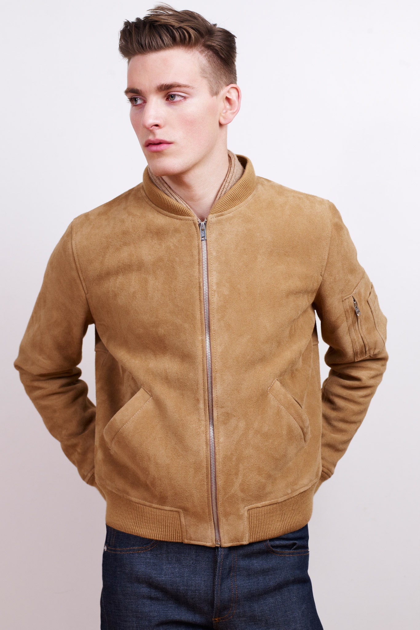brown suede fitted jacket with blue jeans