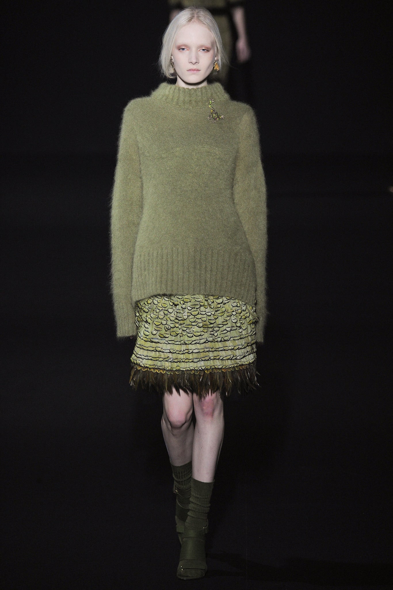 green wool sweater and pleated skirt