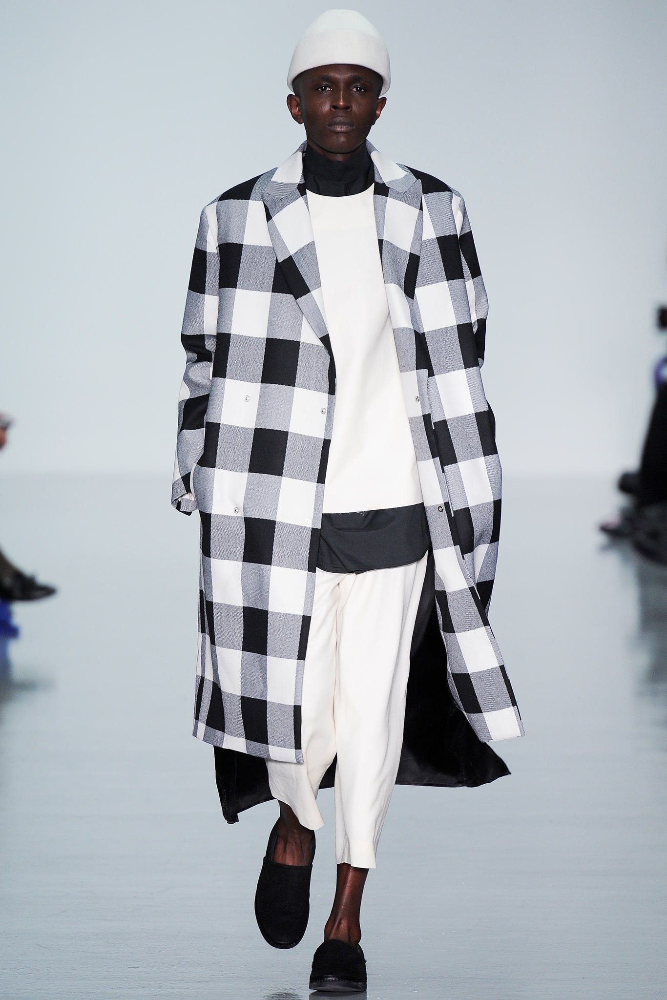 checked coat with white top and pants