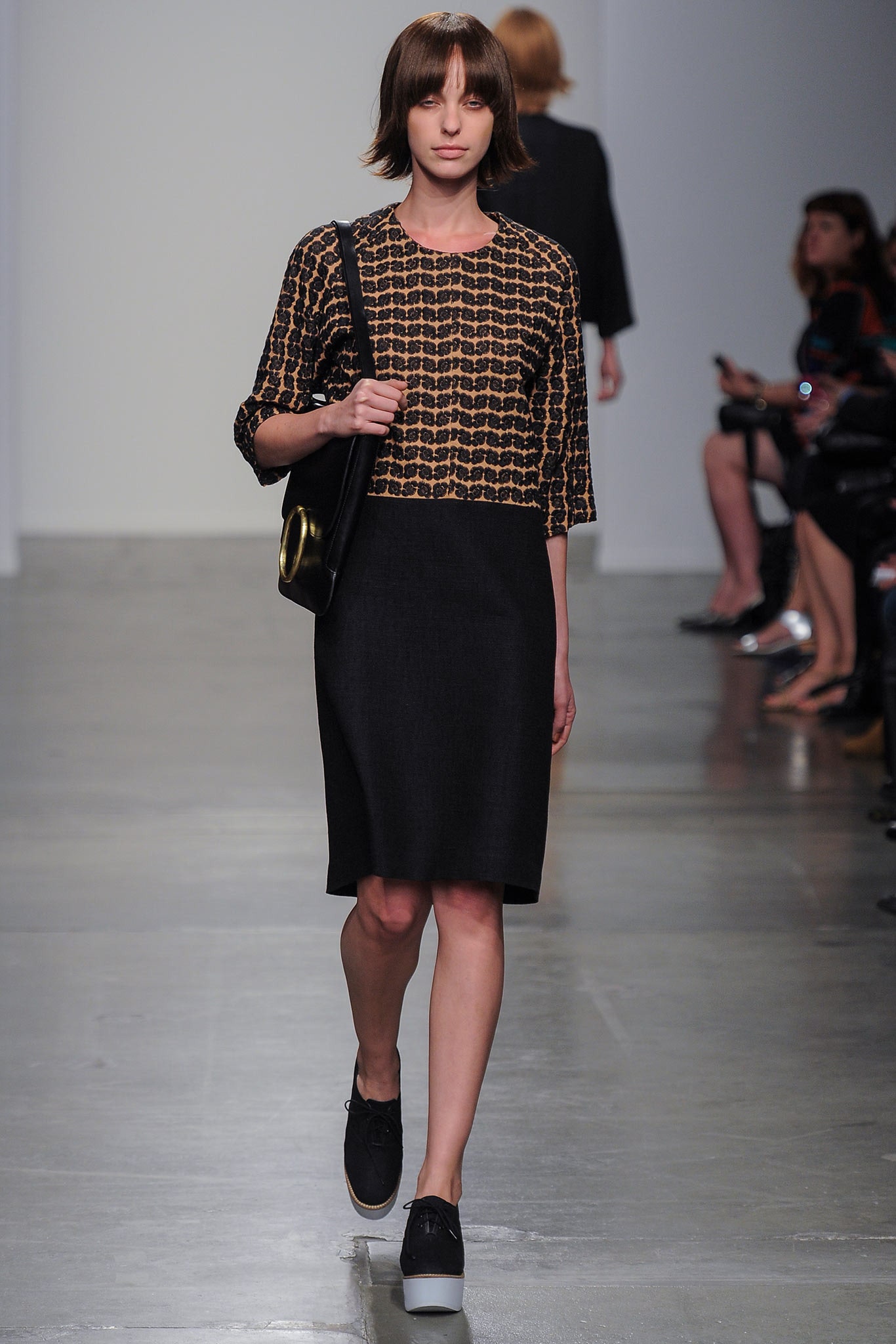 A fitted black dress with three-quarter sleeves and a round neckline, perfect for casual or formal occasions.