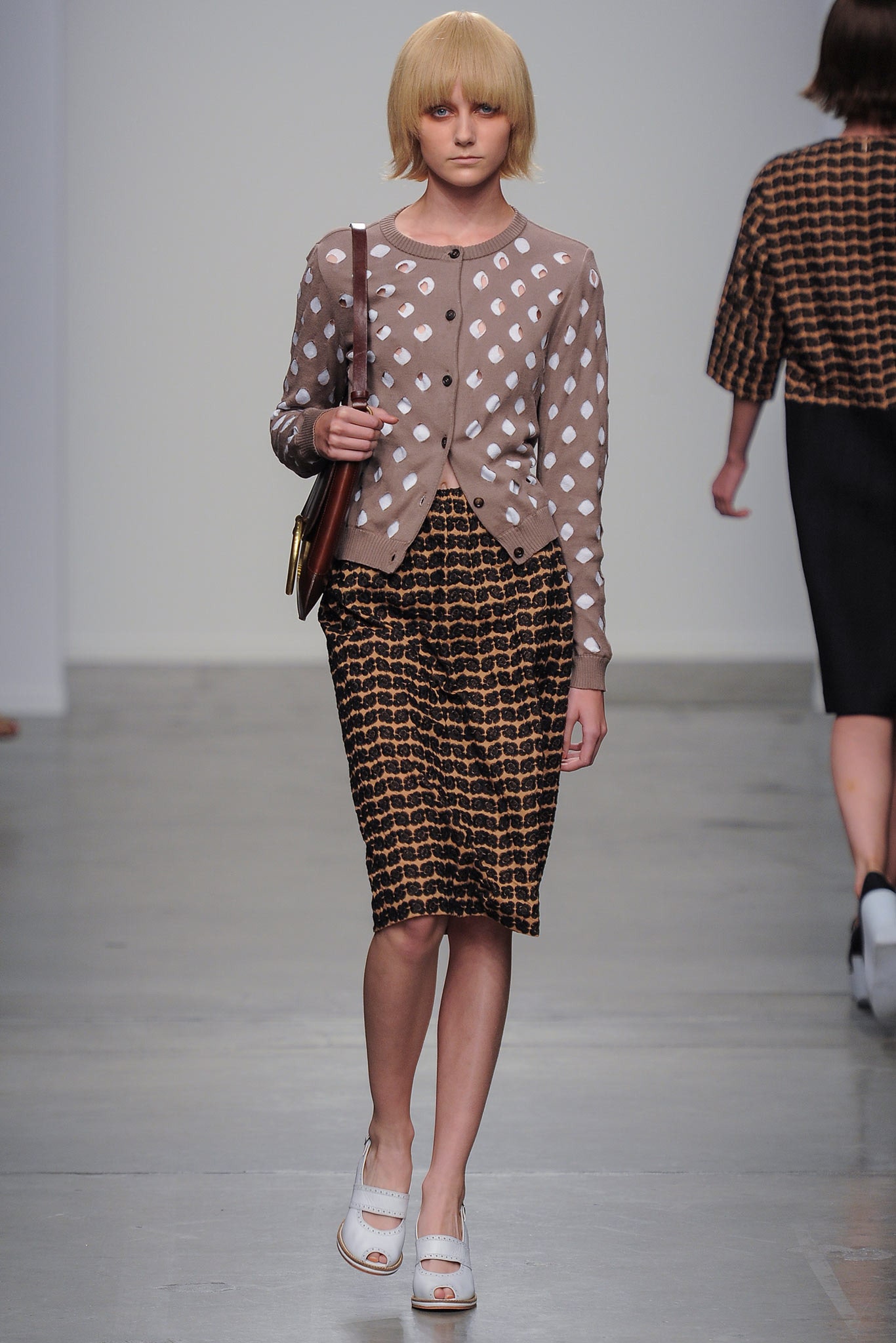A fitted beige printed cardigan paired with a fitted brown pencil skirt.