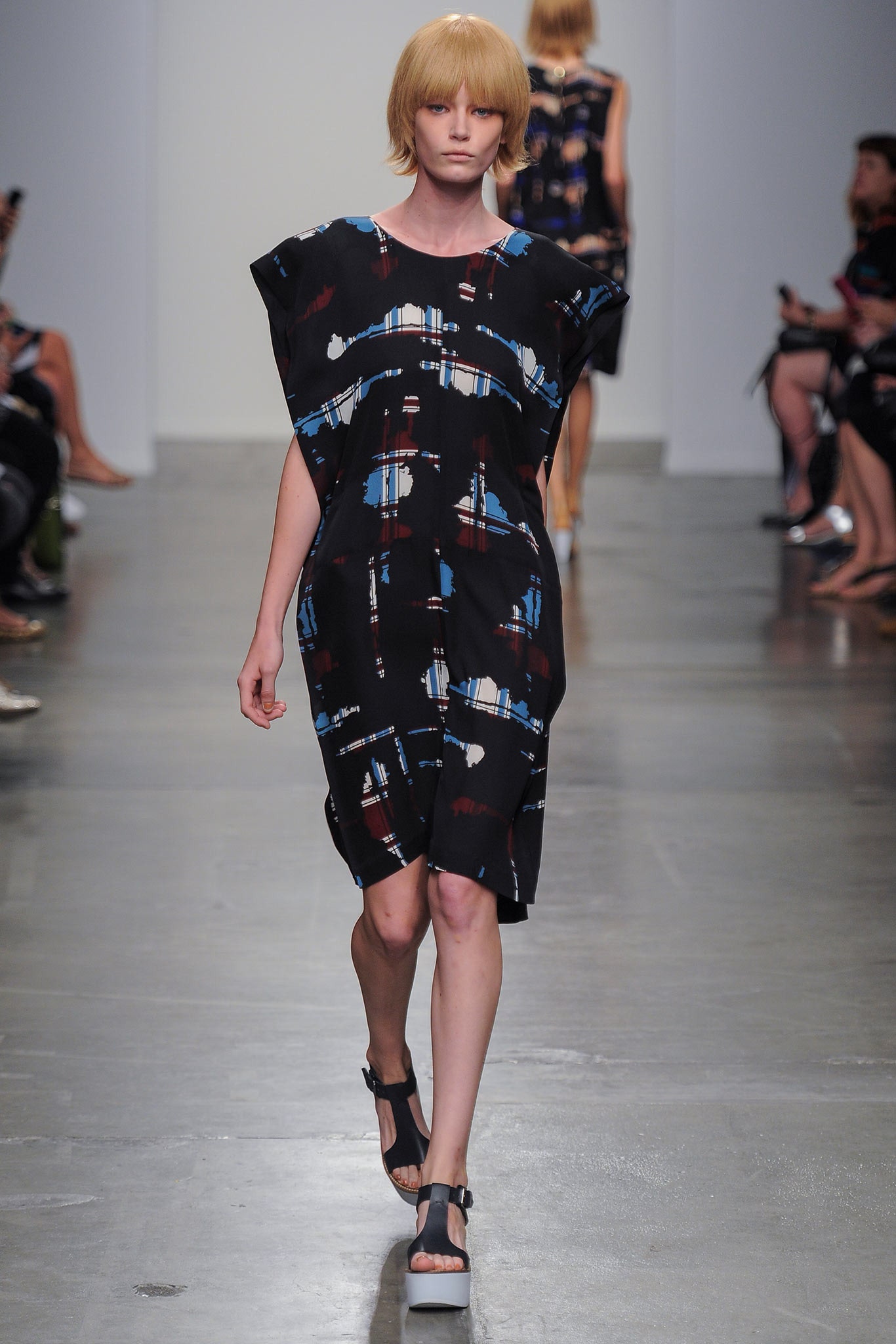 A relaxed black dress with a printed design and sleeveless round-neck construction.