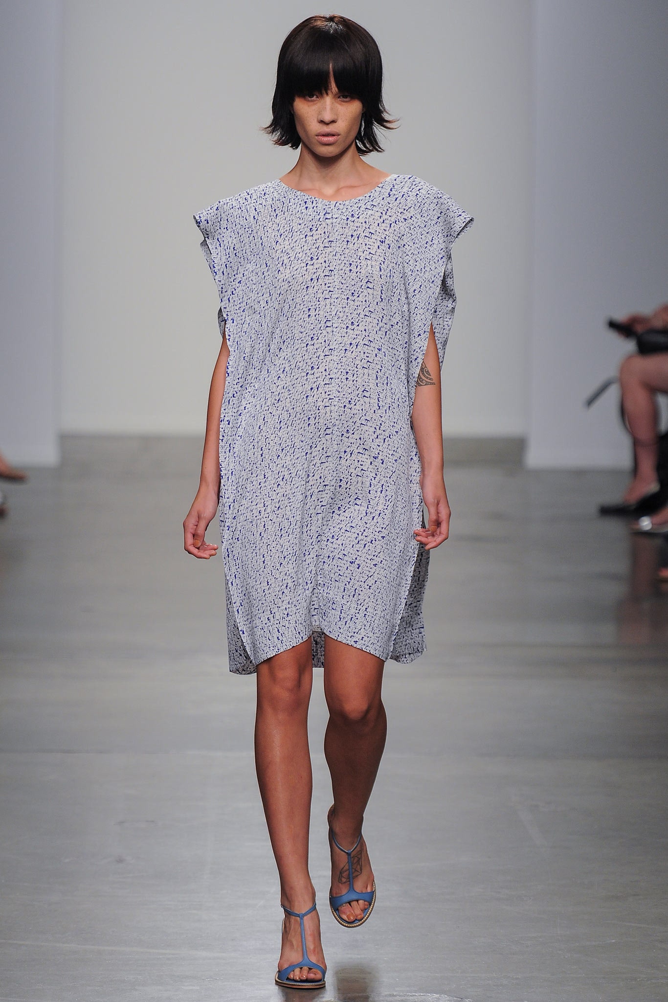 A relaxed blue cotton sleeveless dress featuring a round neckline and a printed design.