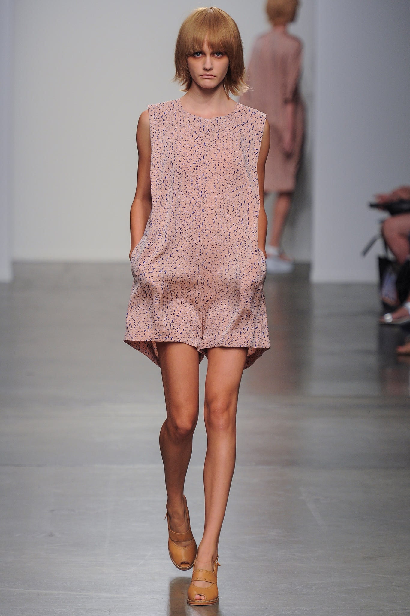 A relaxed pink printed sleeveless romper featuring a collared design.