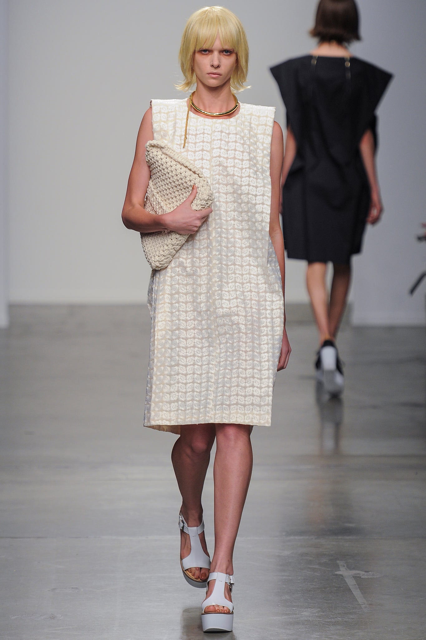 A relaxed white cotton dress with a sleeveless design and collared neckline.
