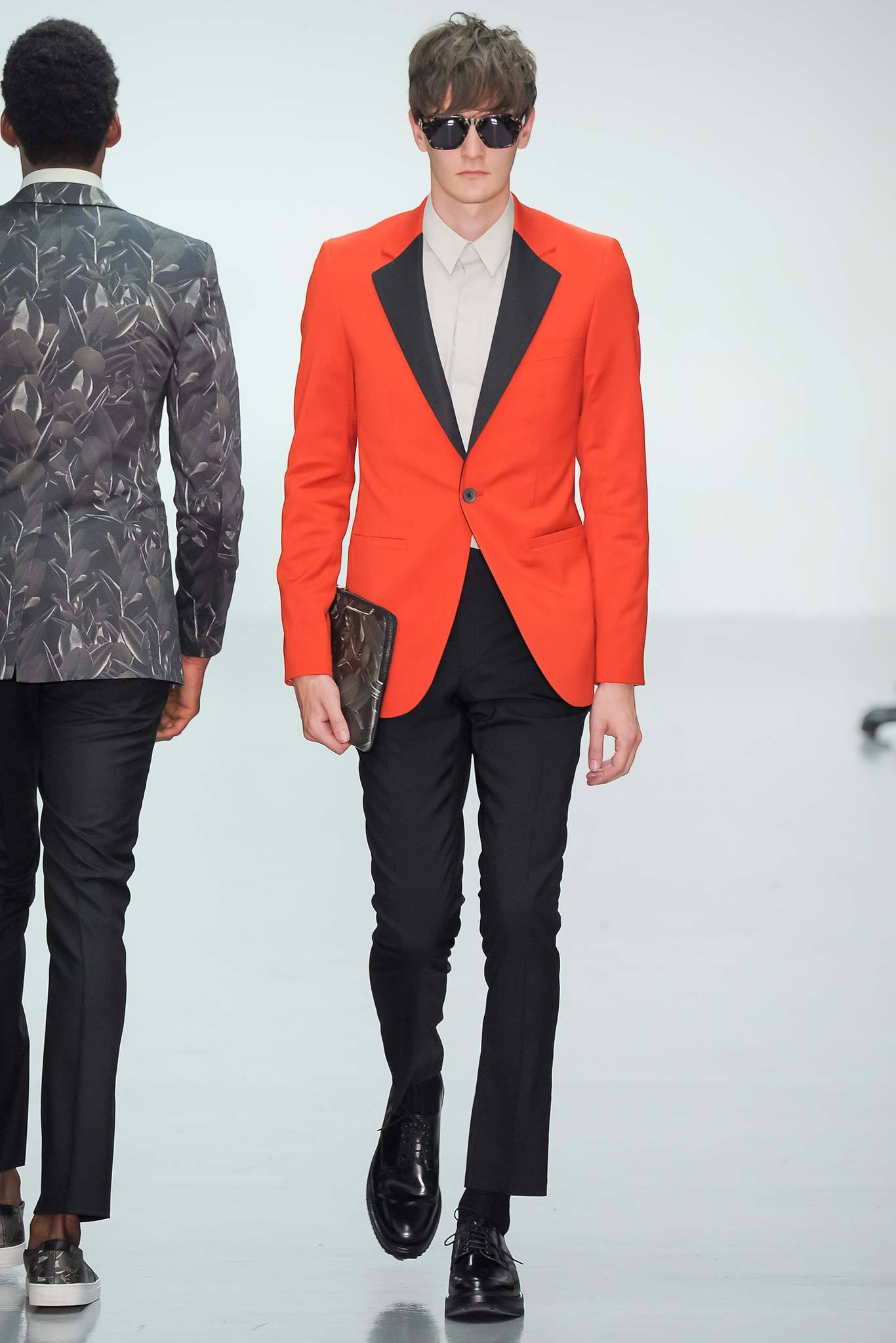 red tailored blazer with black pants