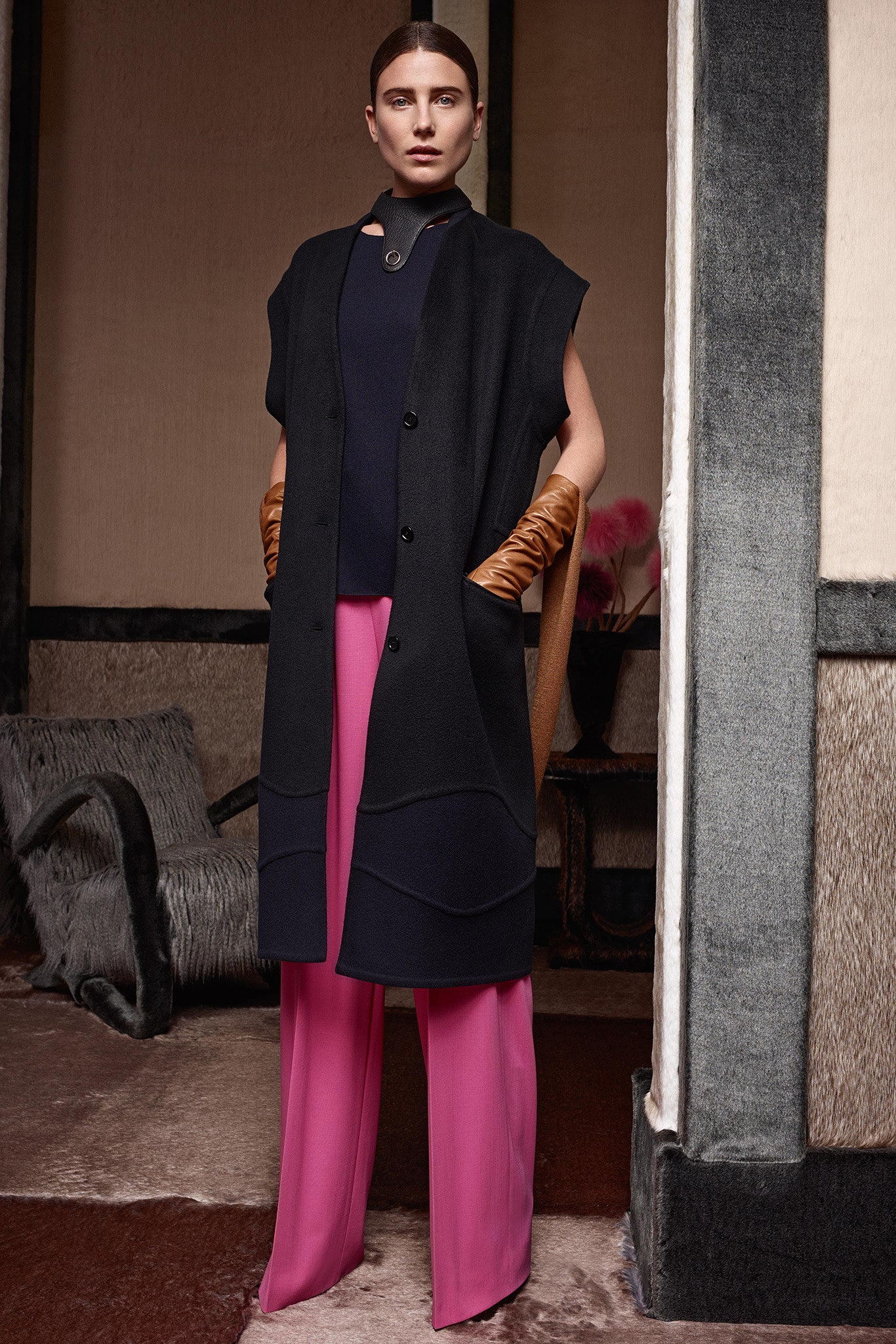 black wool sleeveless coat with pink pants