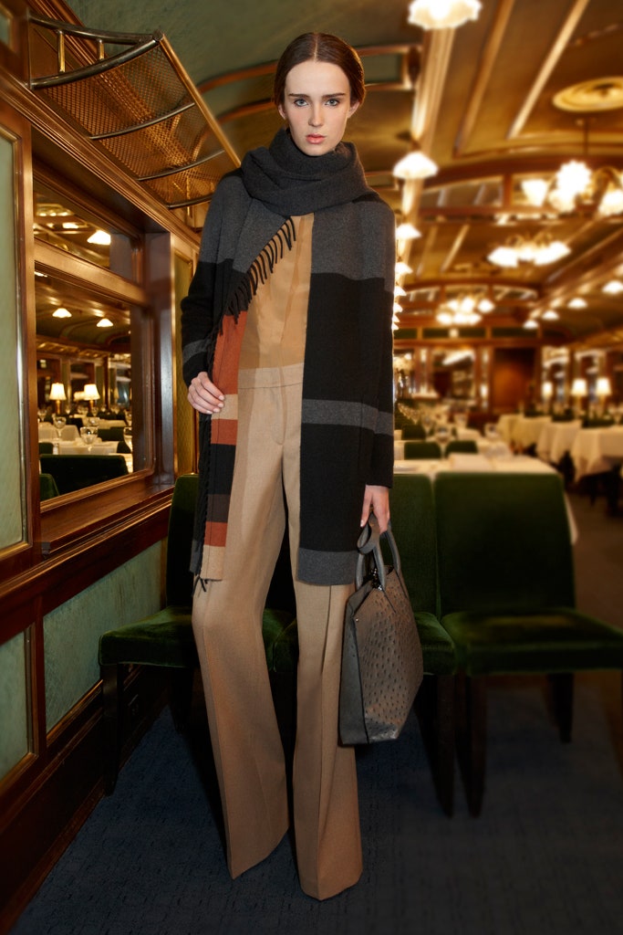 relaxed black wool coat and tailored beige pants