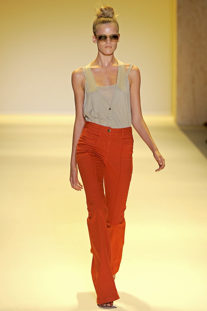 beige fitted top with orange flared pants
