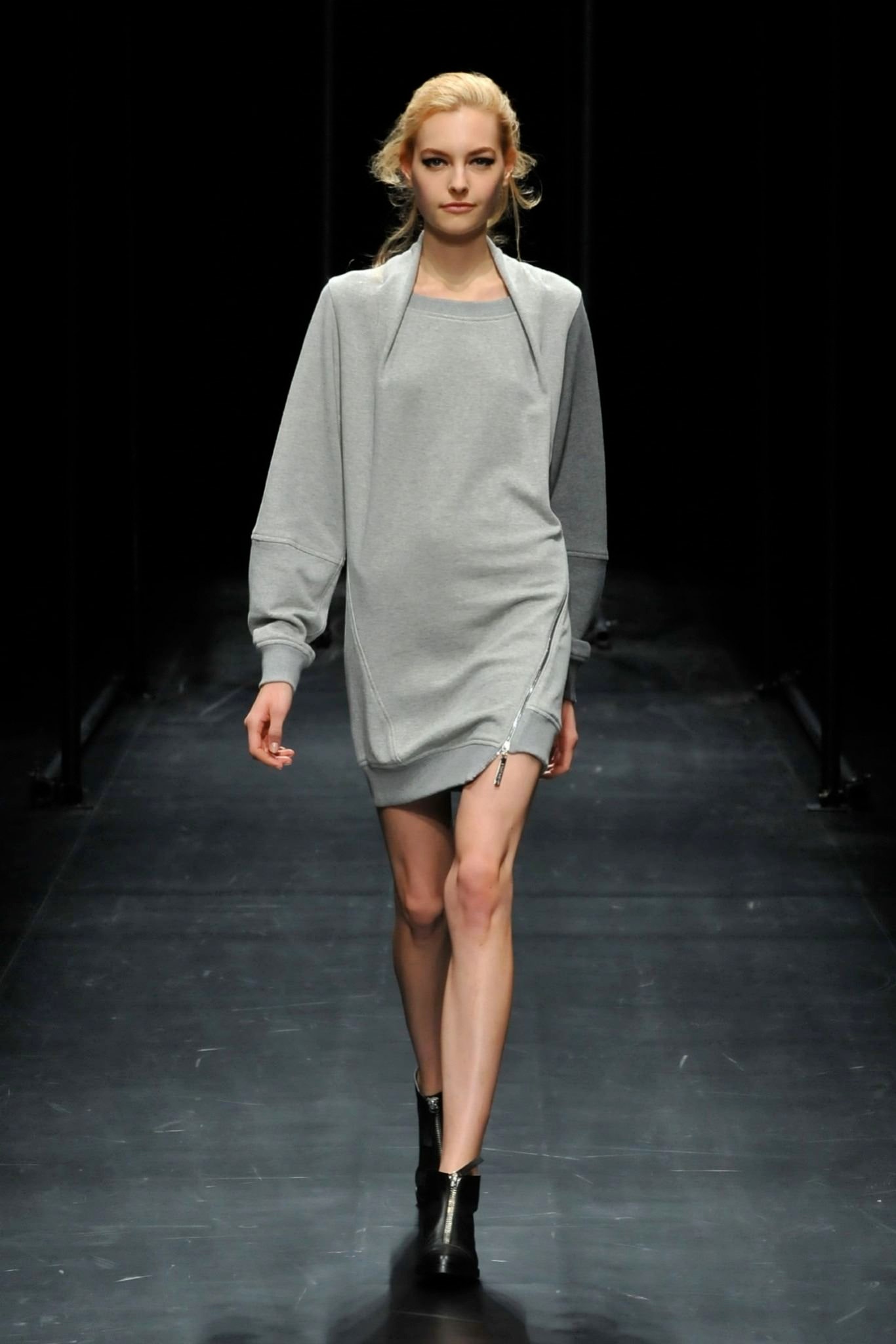 A relaxed gray long-sleeve dress with a crew neckline and asymmetric design detail.