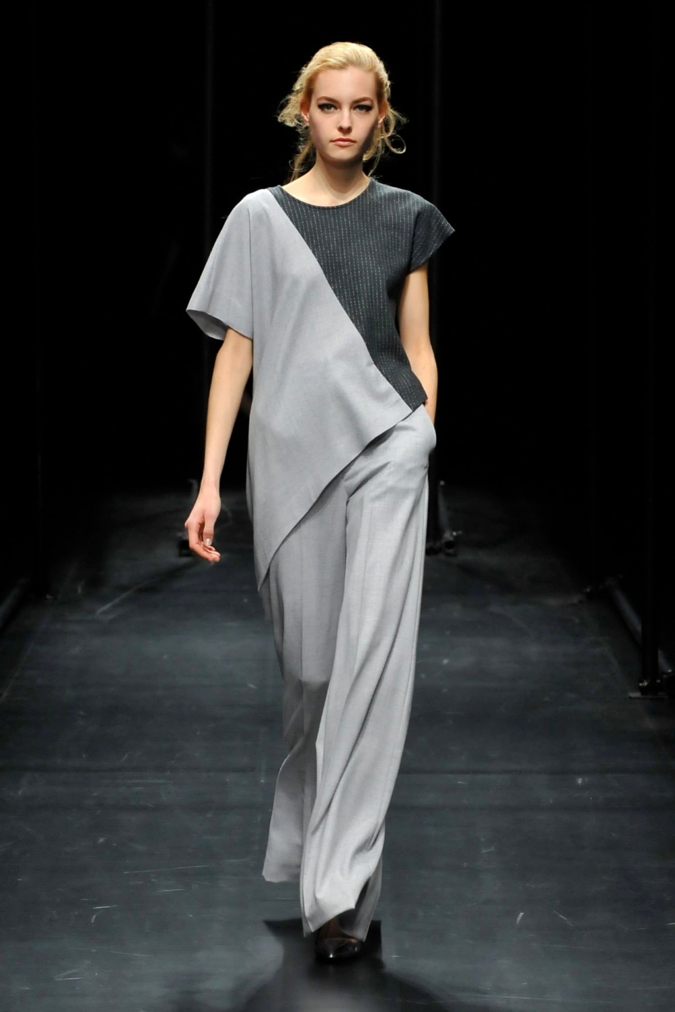 A relaxed gray top with short sleeves and an asymmetric design paired with matching pants.