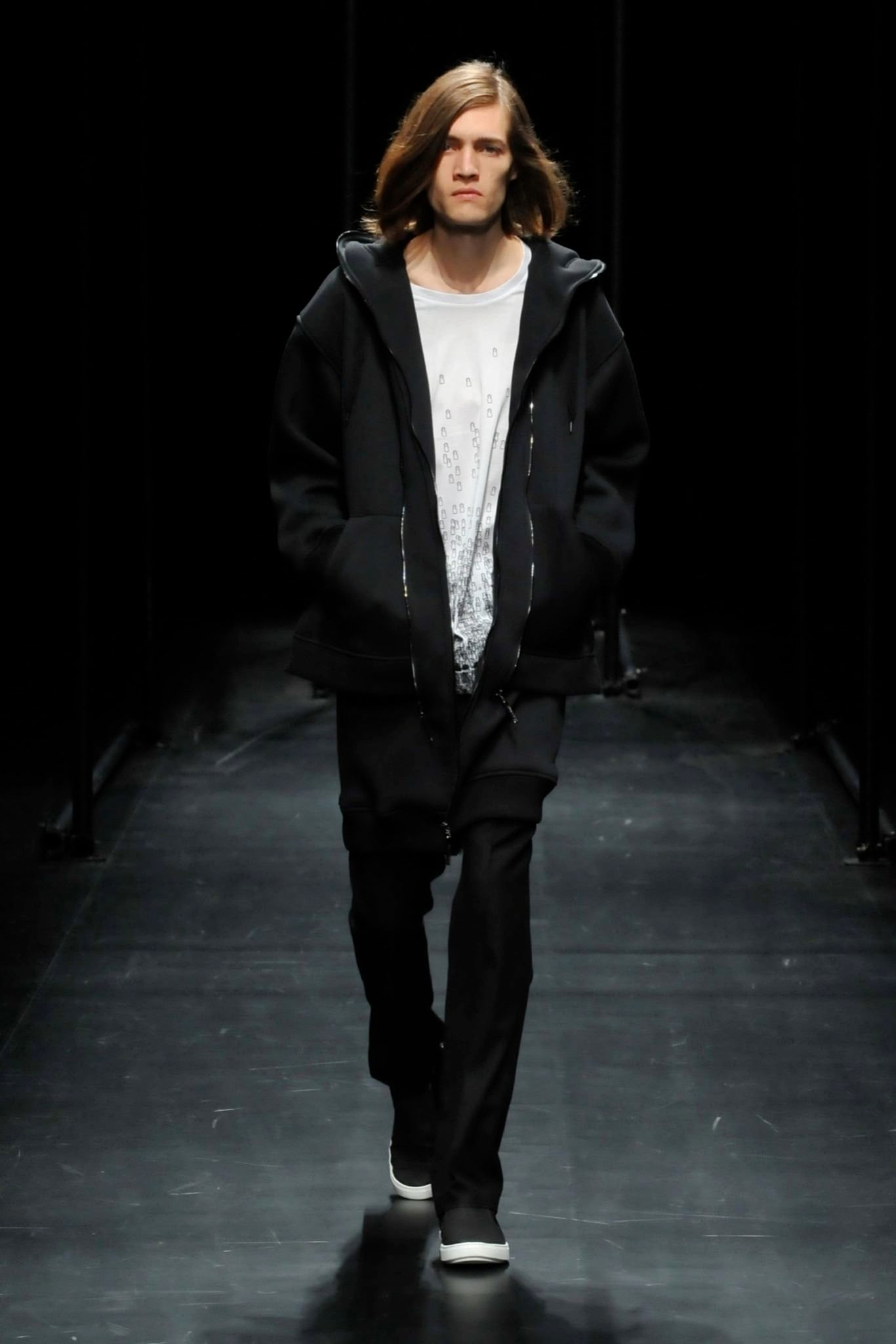 A relaxed black hooded jacket paired with matching pants, featuring a zippered design.