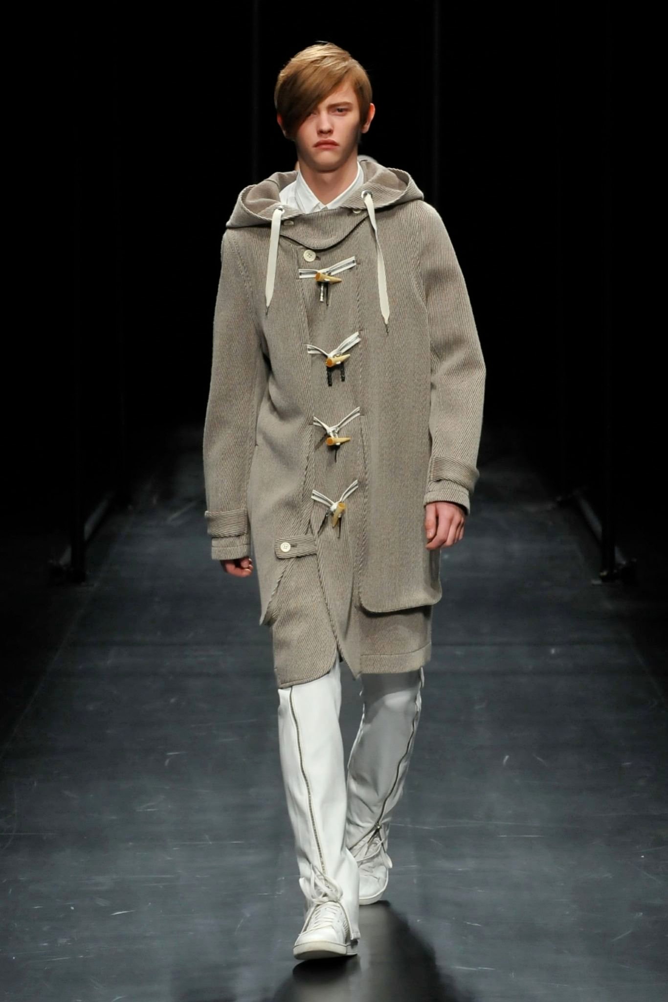 A relaxed gray wool coat with a hood and buttoned details.