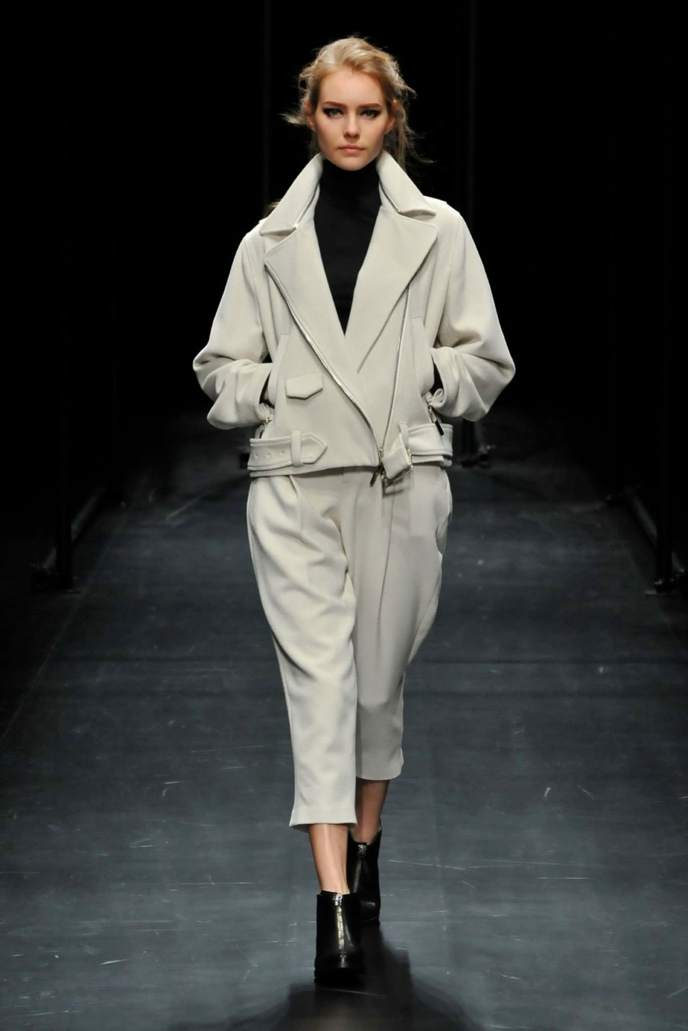 A relaxed white jacket with long sleeves and a collared design paired with matching pants.
