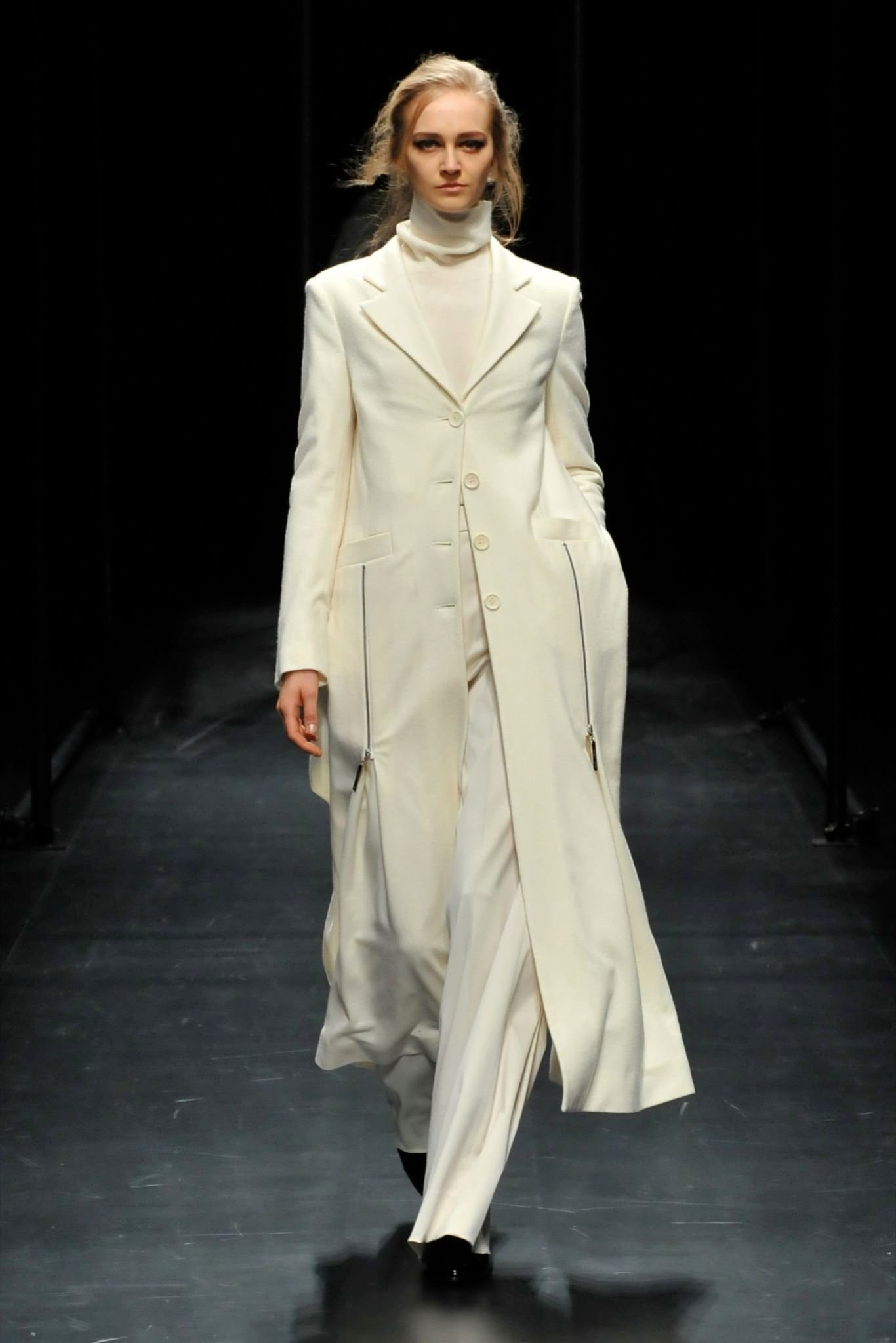 A fitted white wool coat with a collared neckline and straight-leg pants.