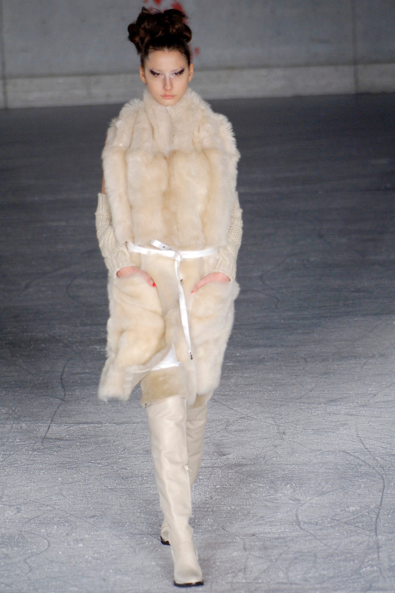 beige fur coat and white boots