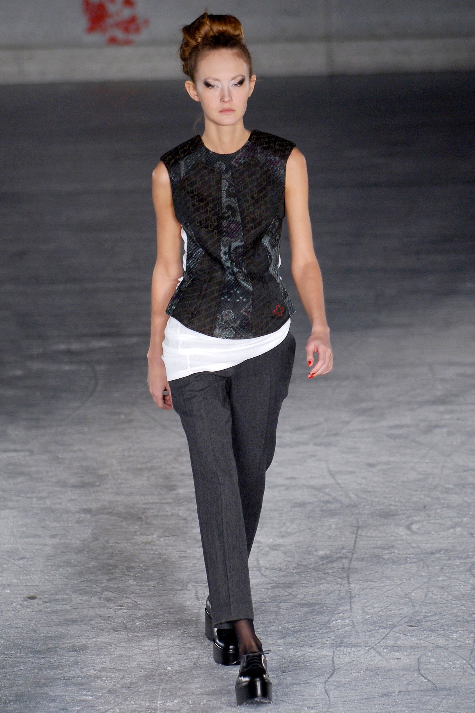 black silk sleeveless top and gray tailored pants