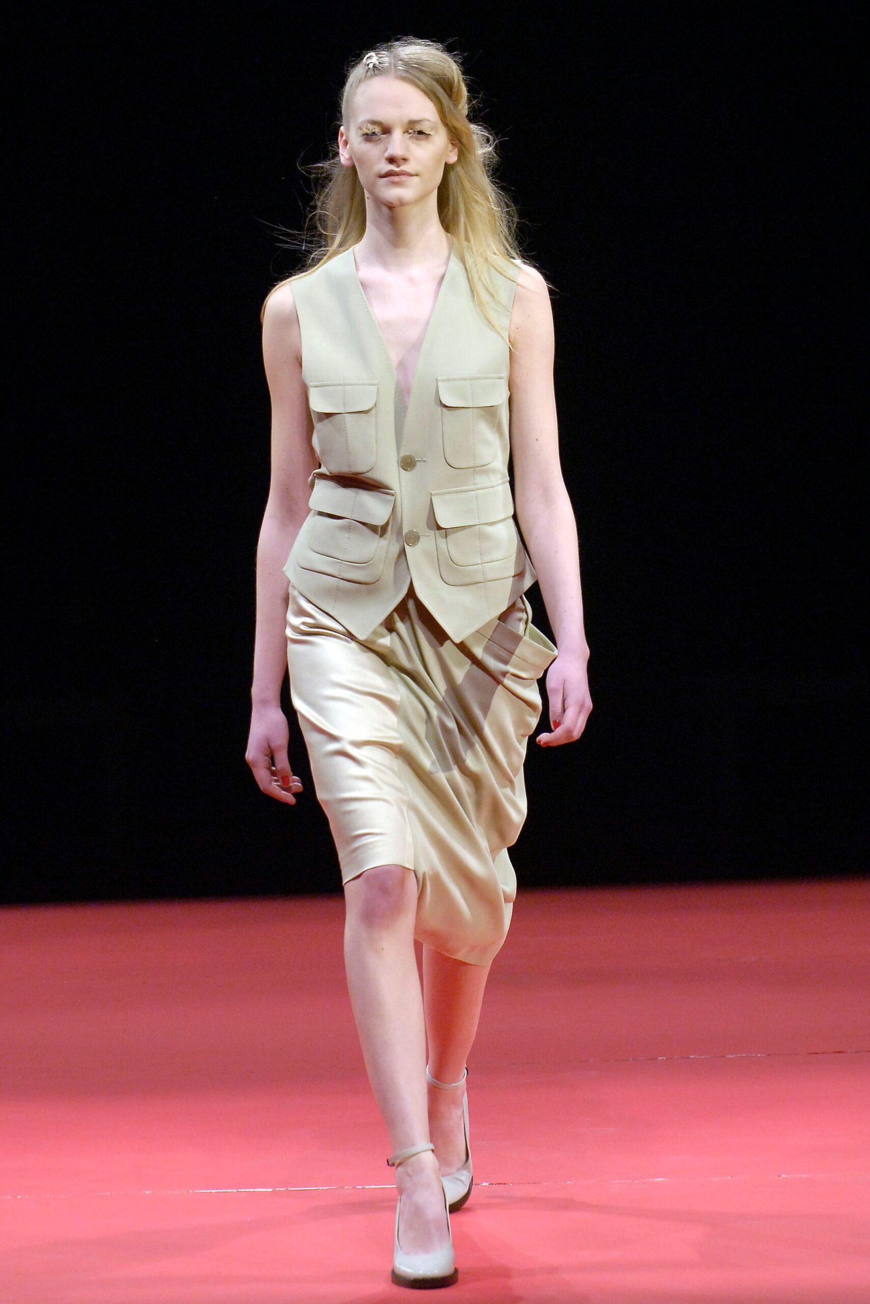 beige fitted vest with gold skirt