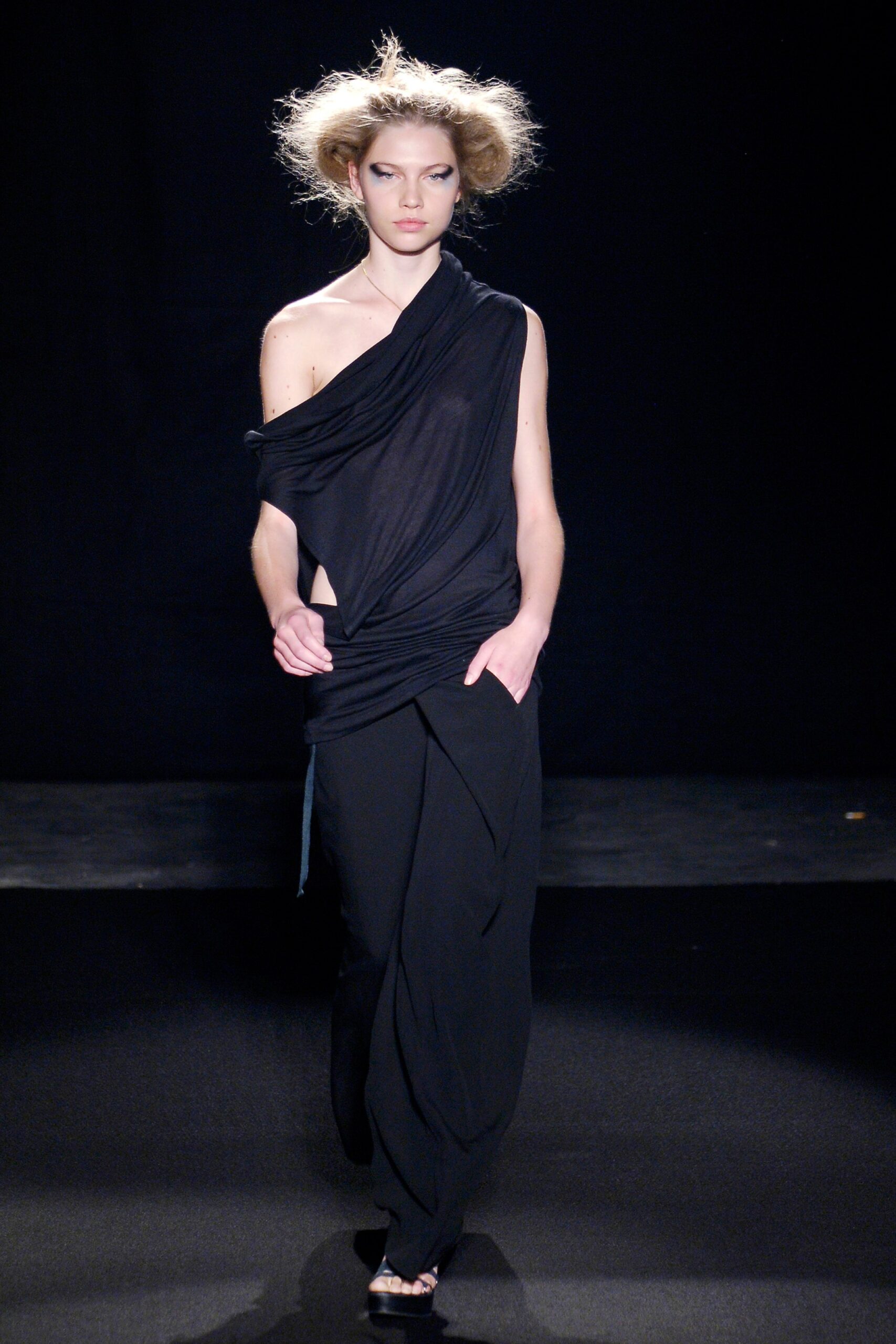 black draped top and wide-leg pants