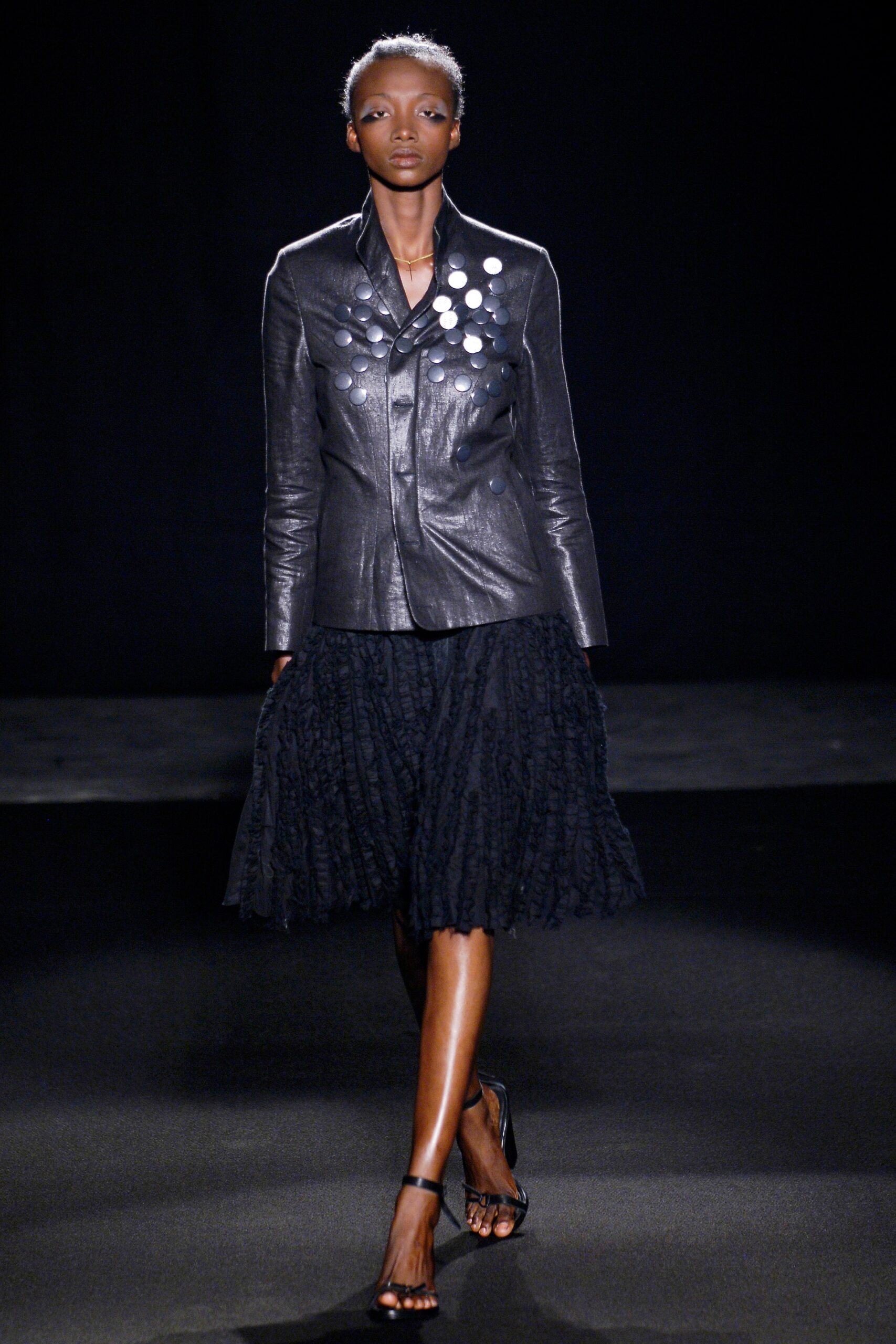 black leather fitted jacket and pleated skirt