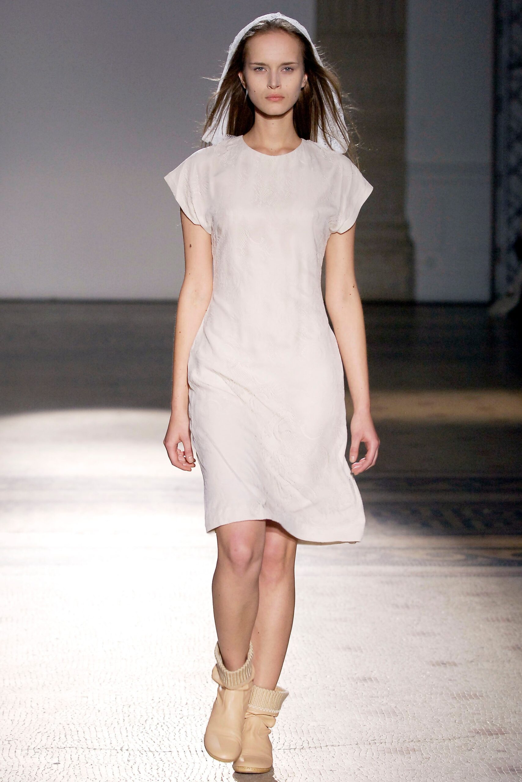 white fitted mini dress with beige boots