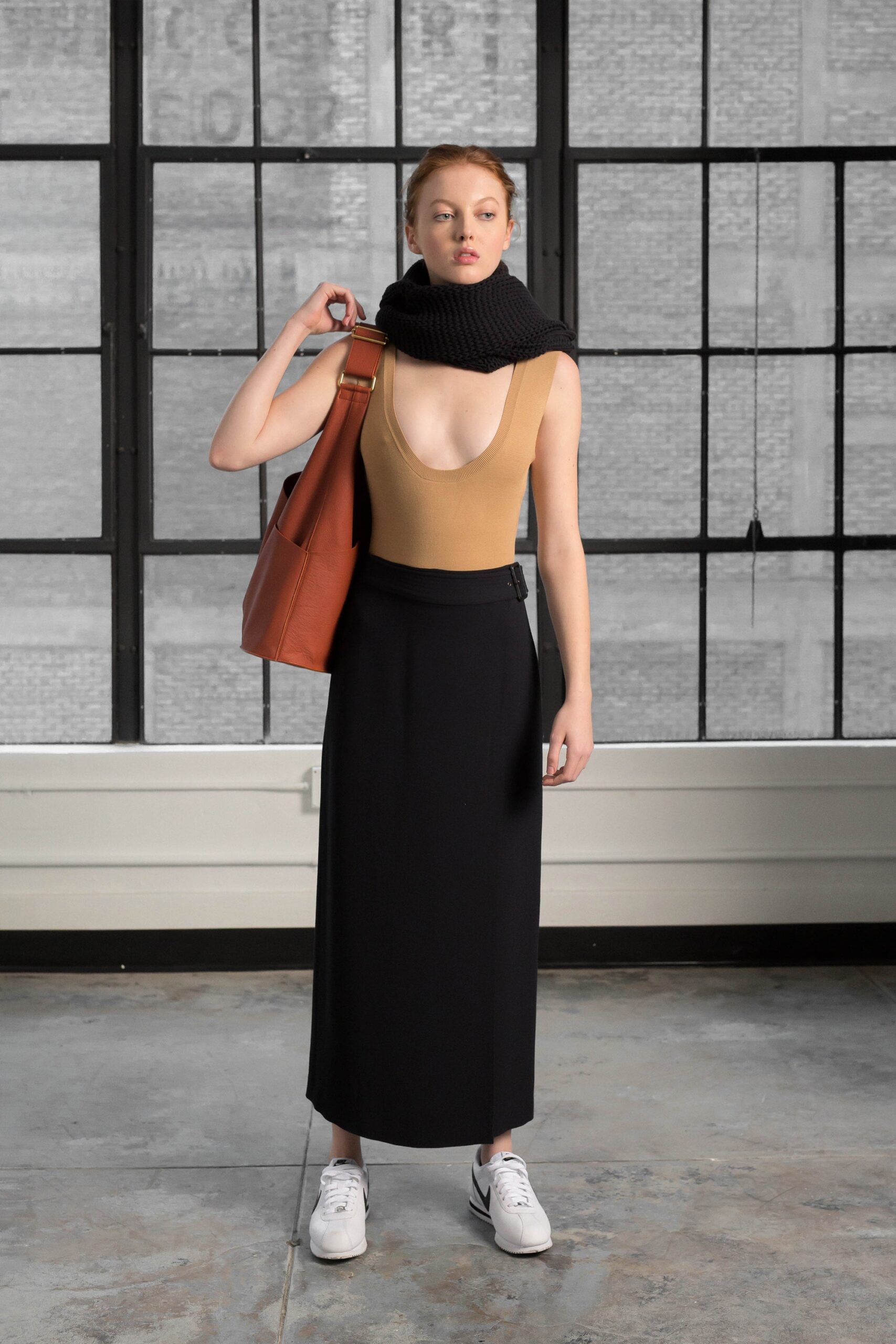 beige sleeveless top with black midi skirt