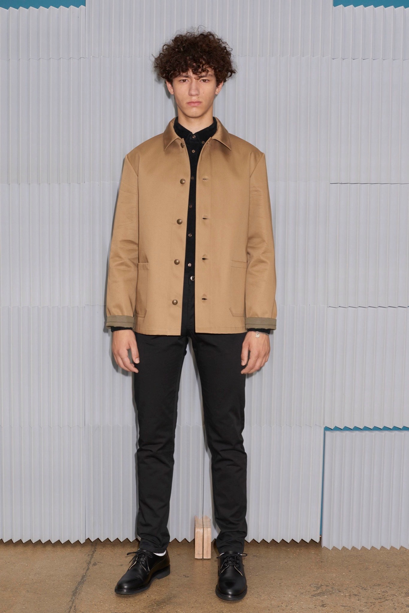 beige jacket black shirt and pants