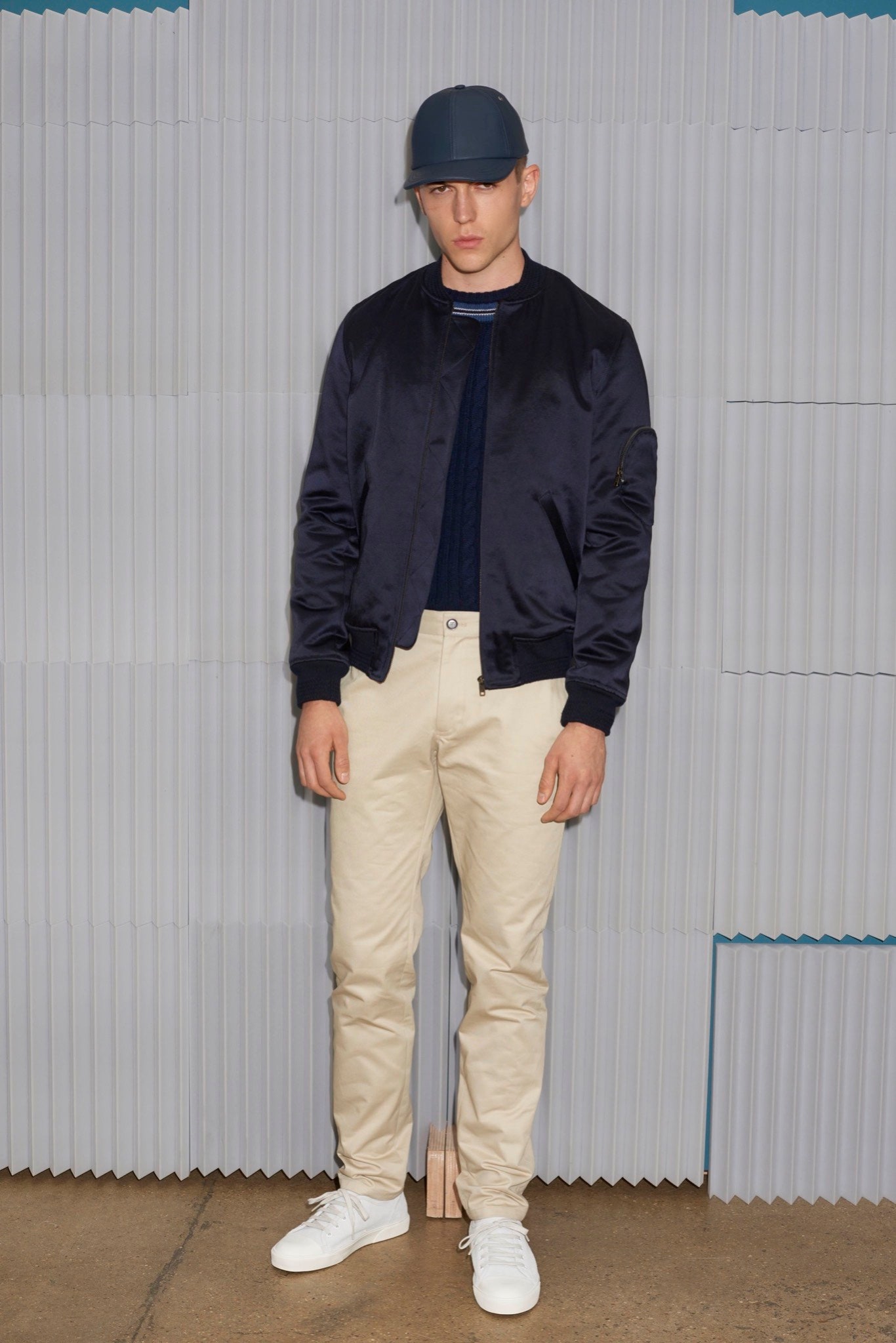 black jacket blue shirt beige pants