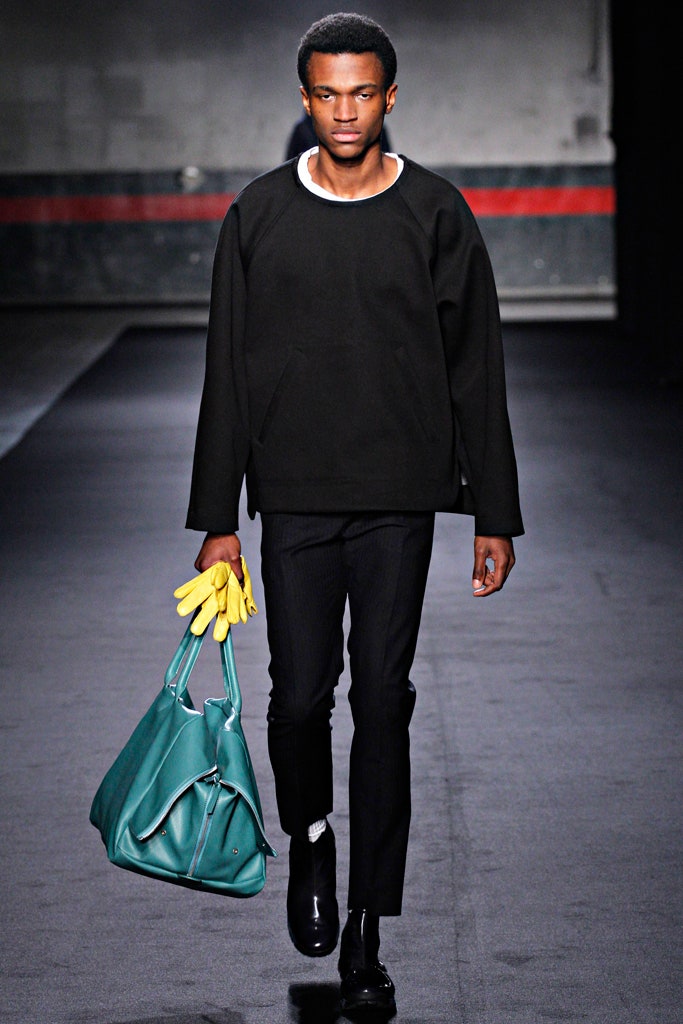 black relaxed sweater with teal bag