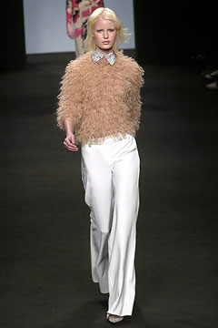 beige fur top with white pants