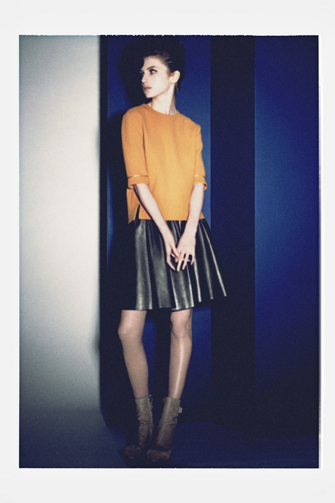 orange cotton top with black leather skirt