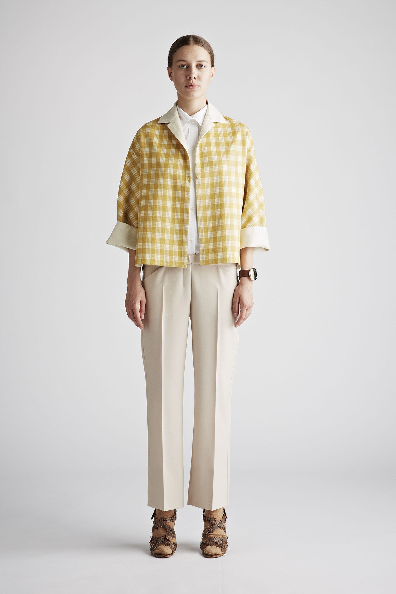 yellow checked jacket with beige pants
