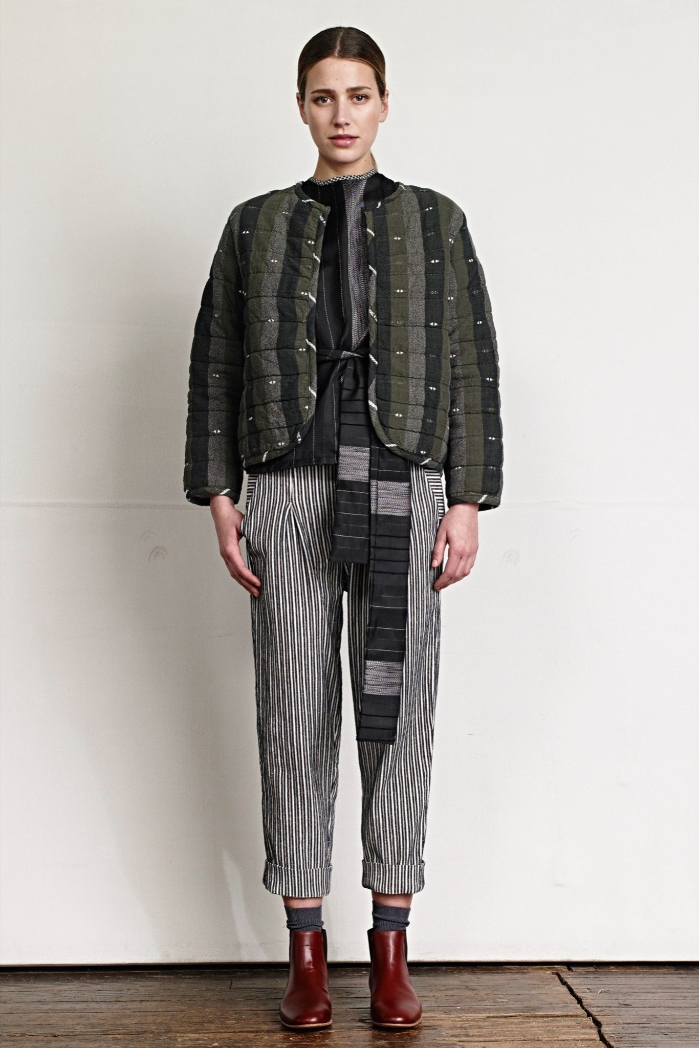 green quilted jacket with striped pants