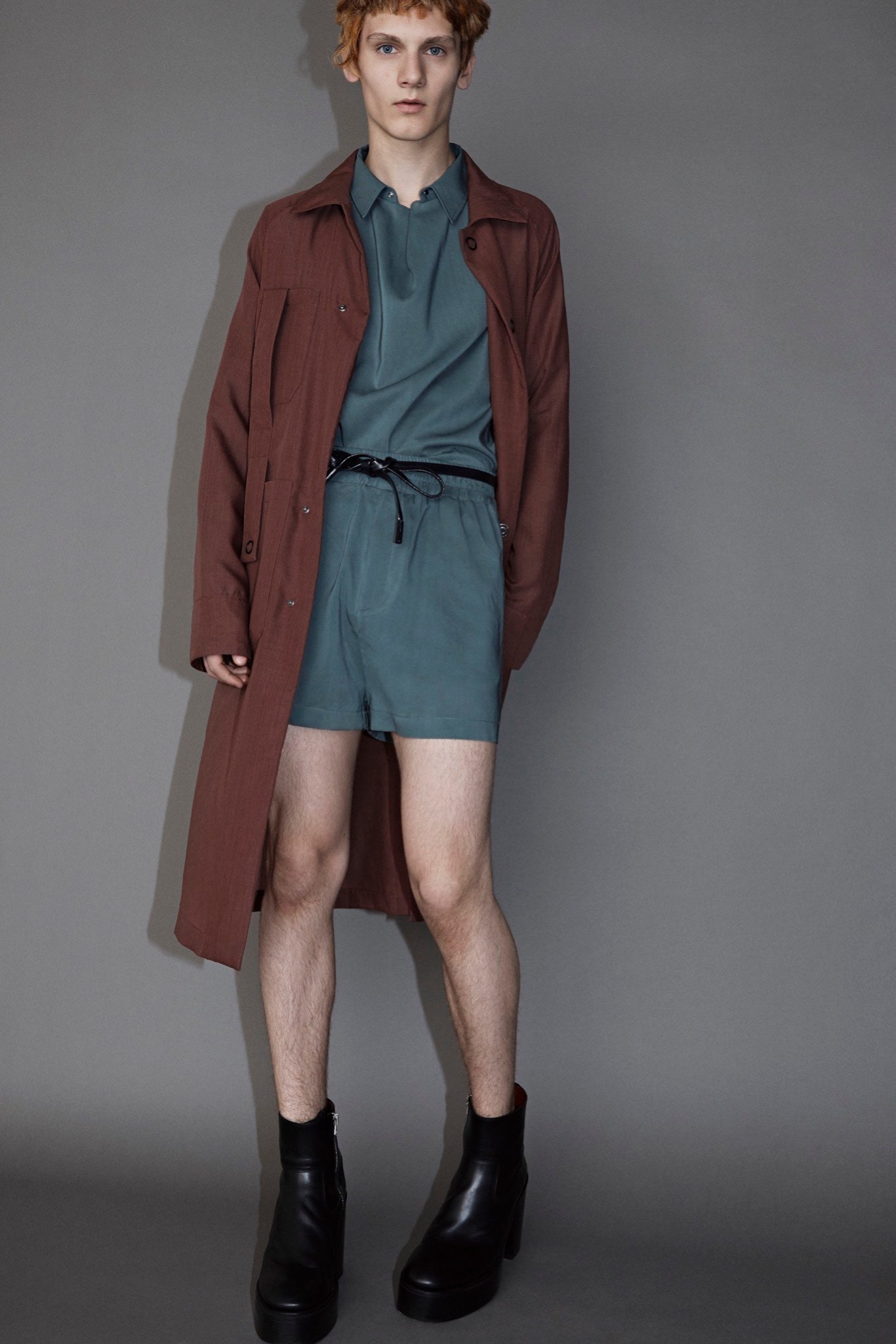 brown coat teal shirt shorts