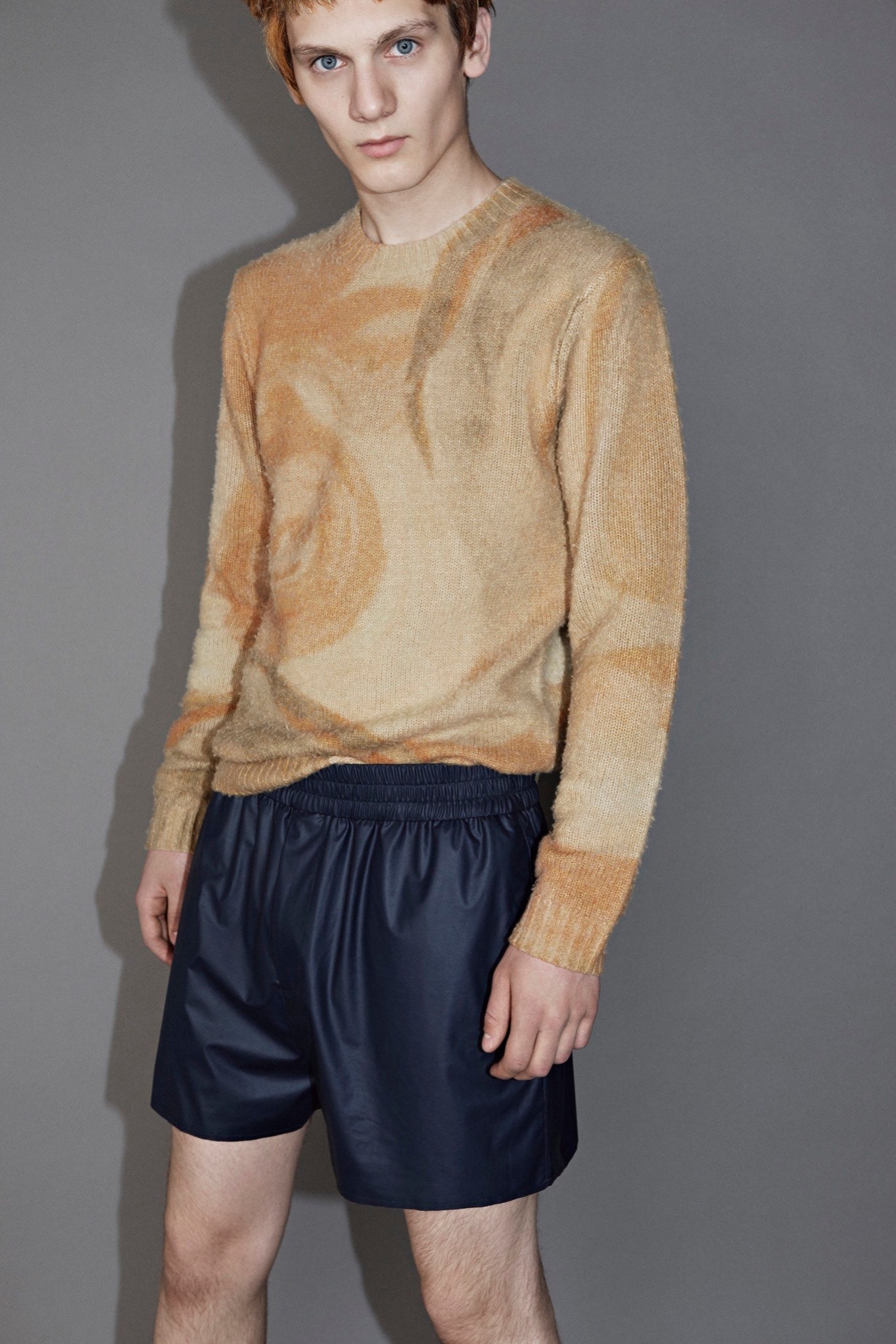 beige printed wool sweater and navy shorts