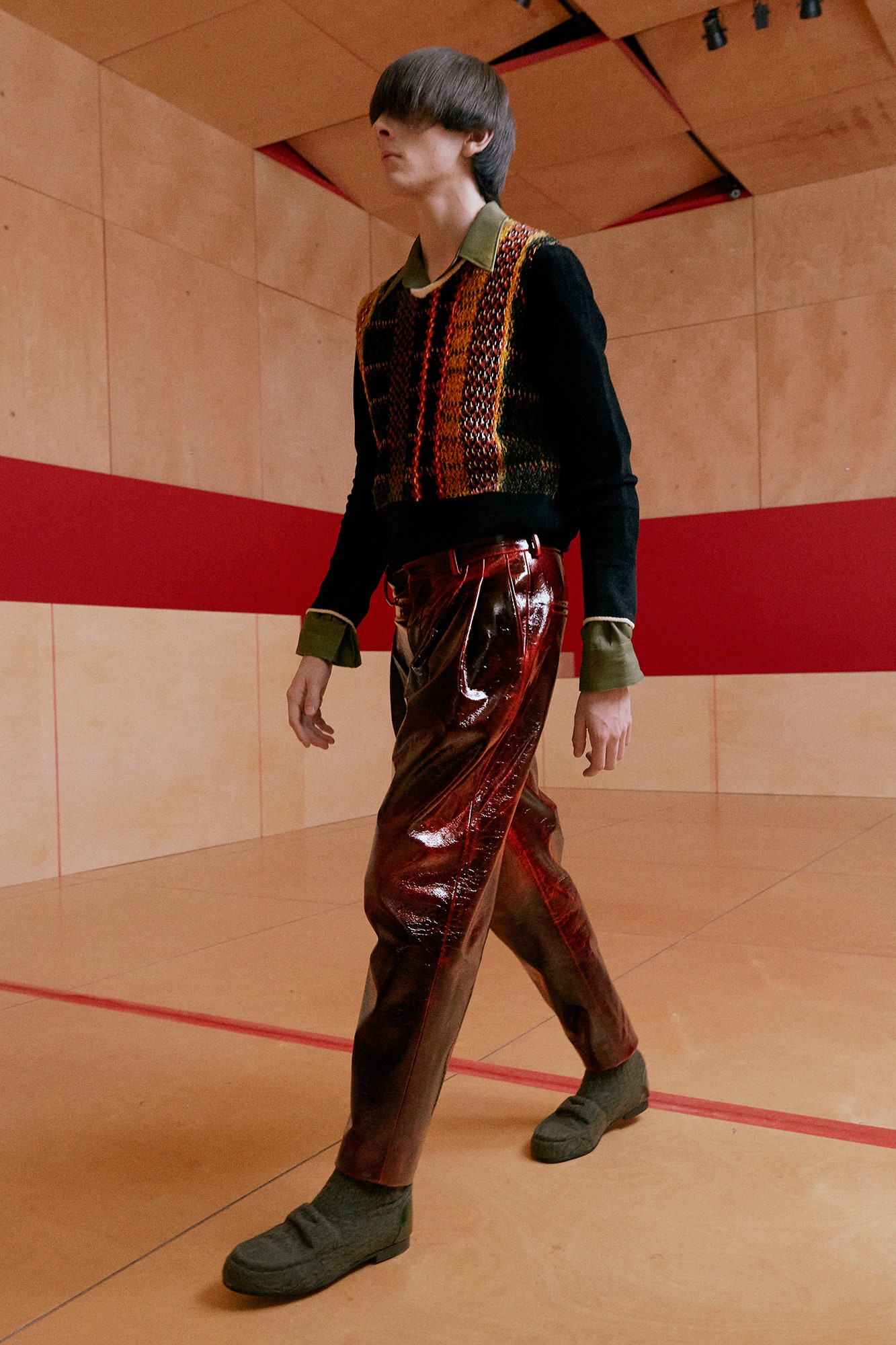 black and red layered sweater with vinyl pants