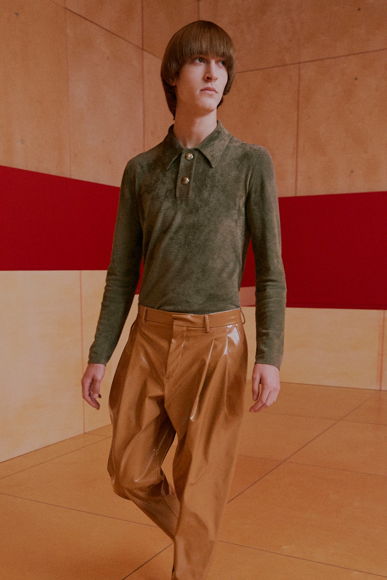 green fitted shirt and brown pants
