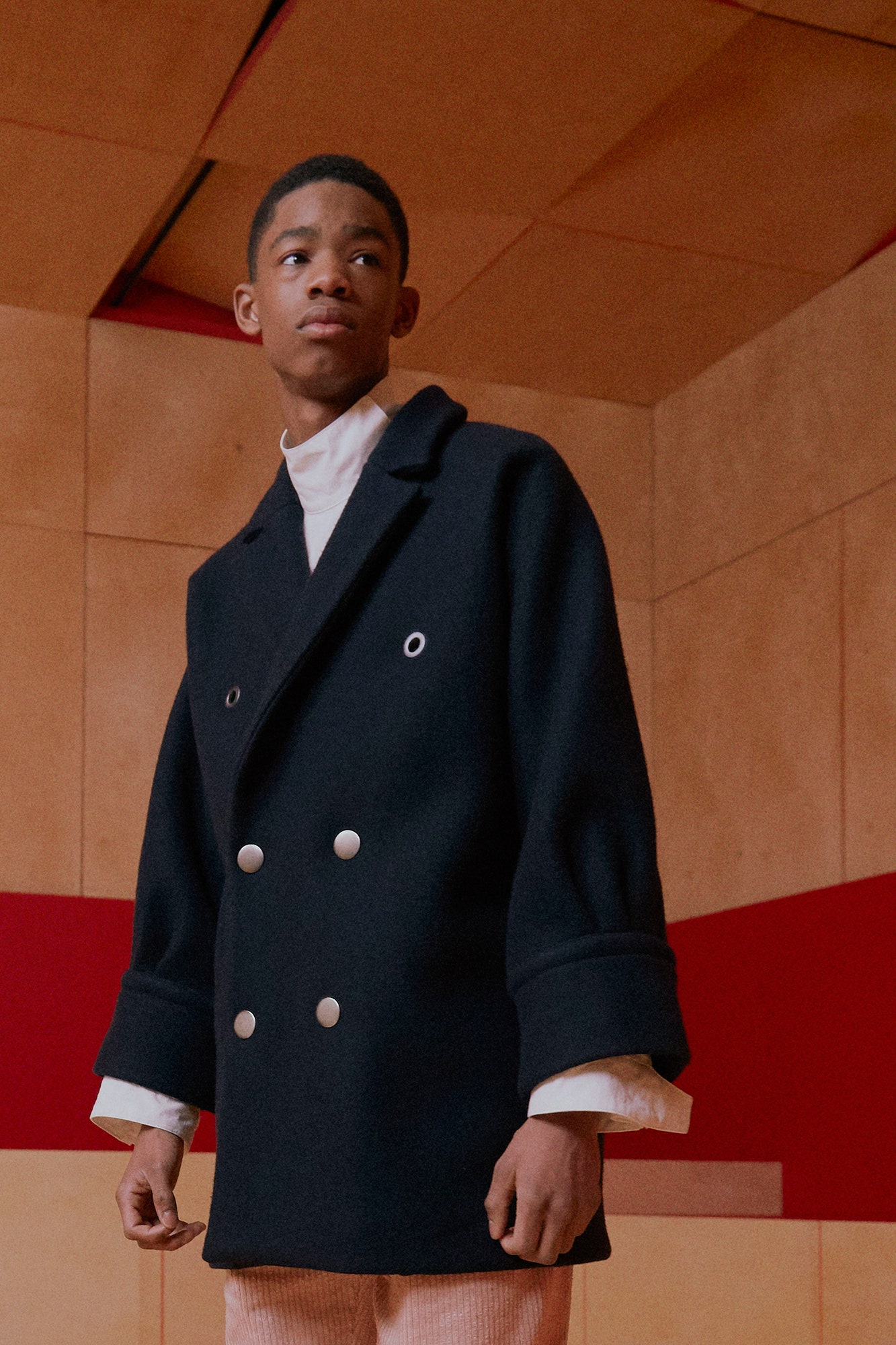 black wool relaxed coat and white shirt