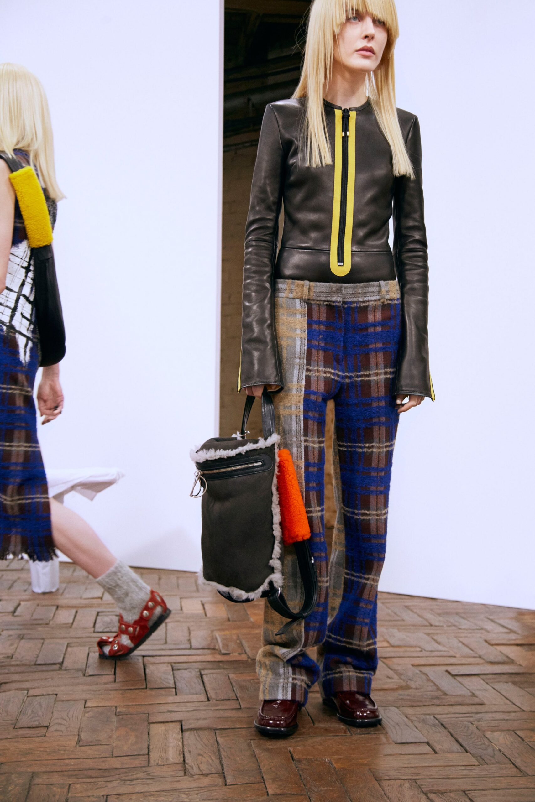 black leather fitted top with yellow zipper