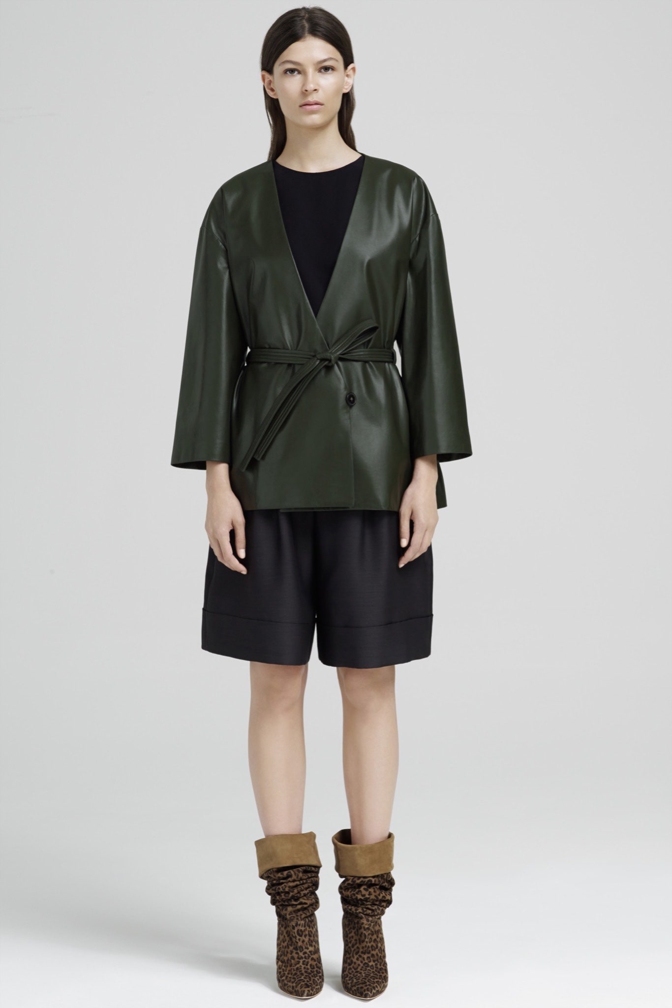 green leather jacket with black shorts