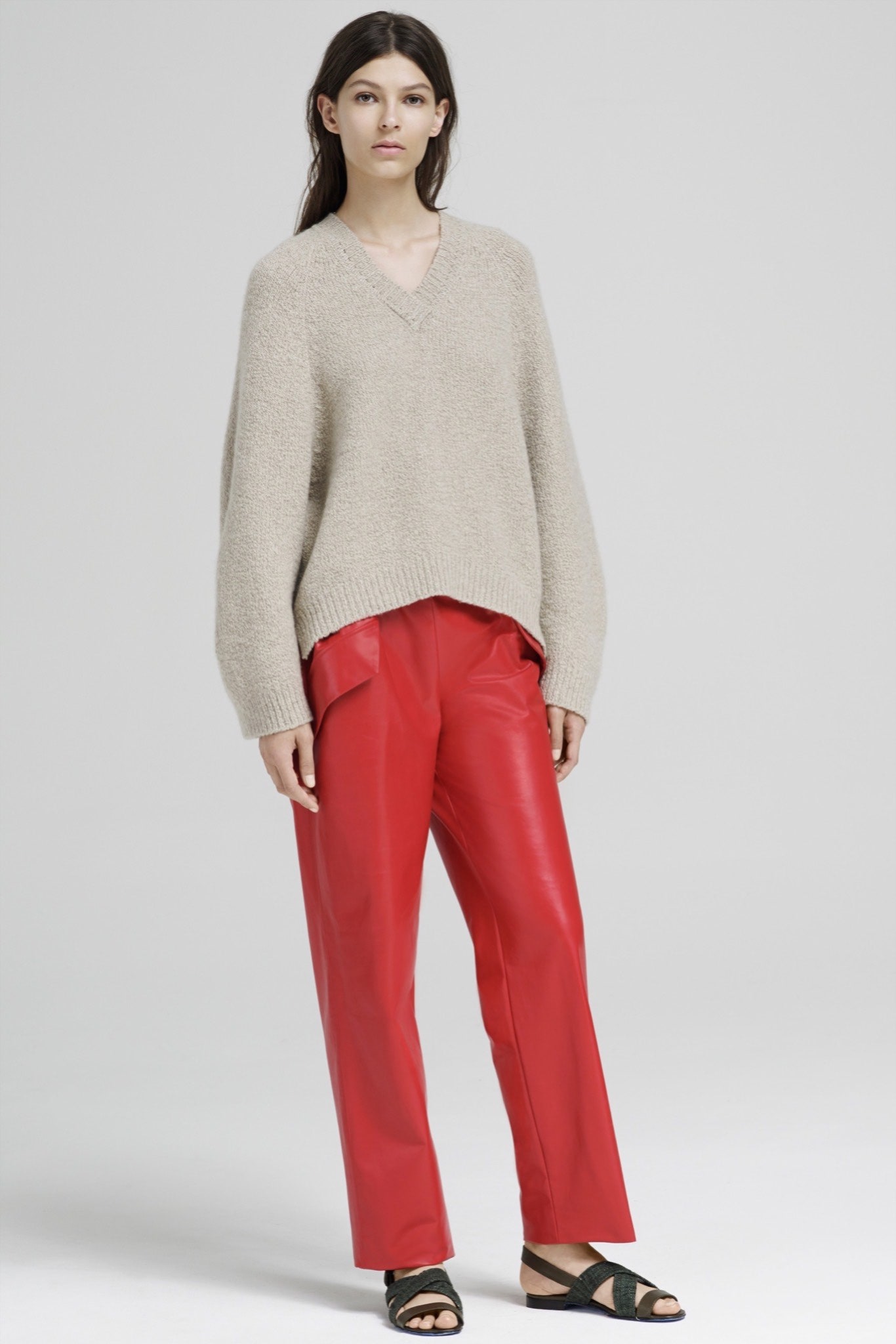 beige wool sweater and red leather pants